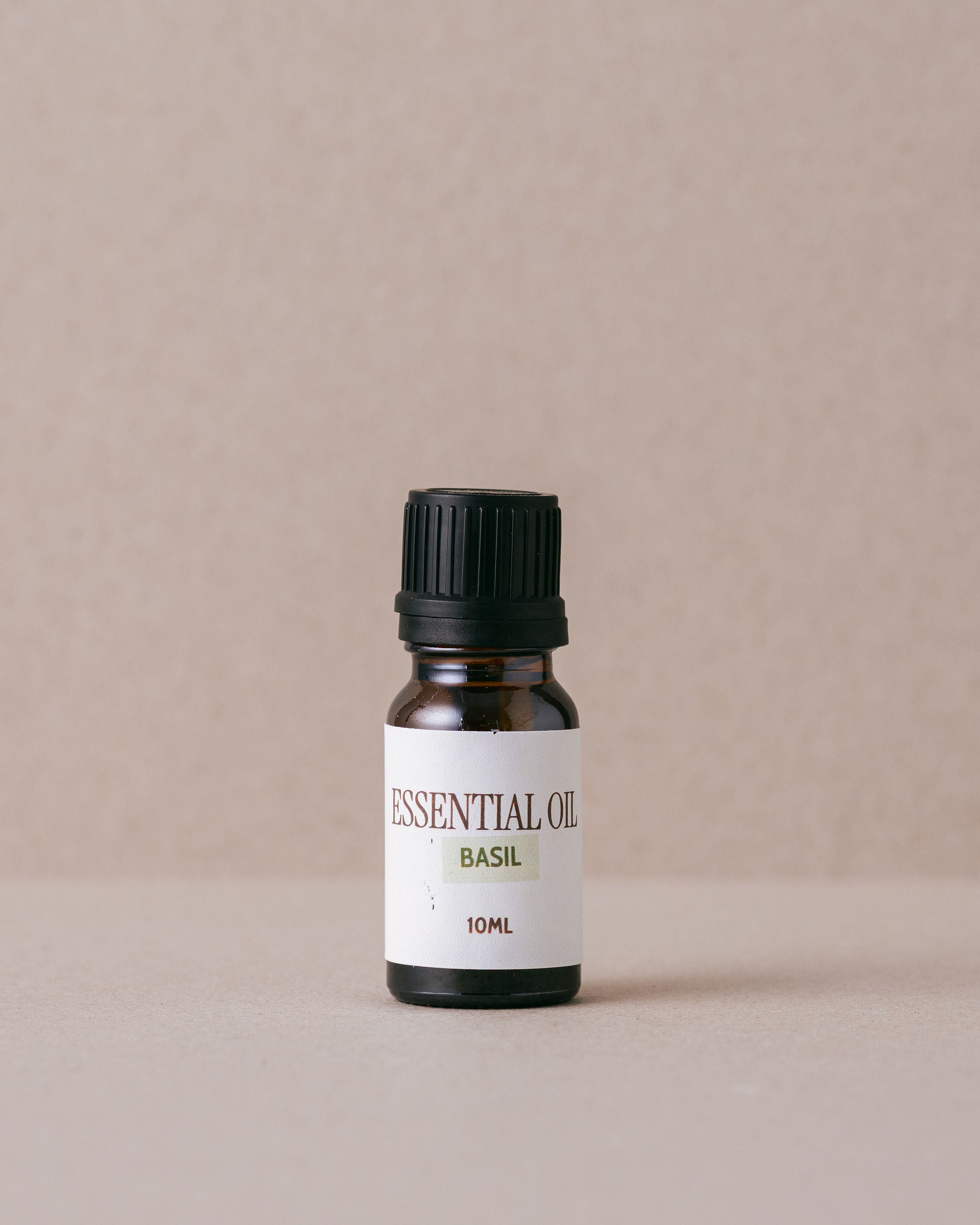 Basil essential oil in small glass bottle