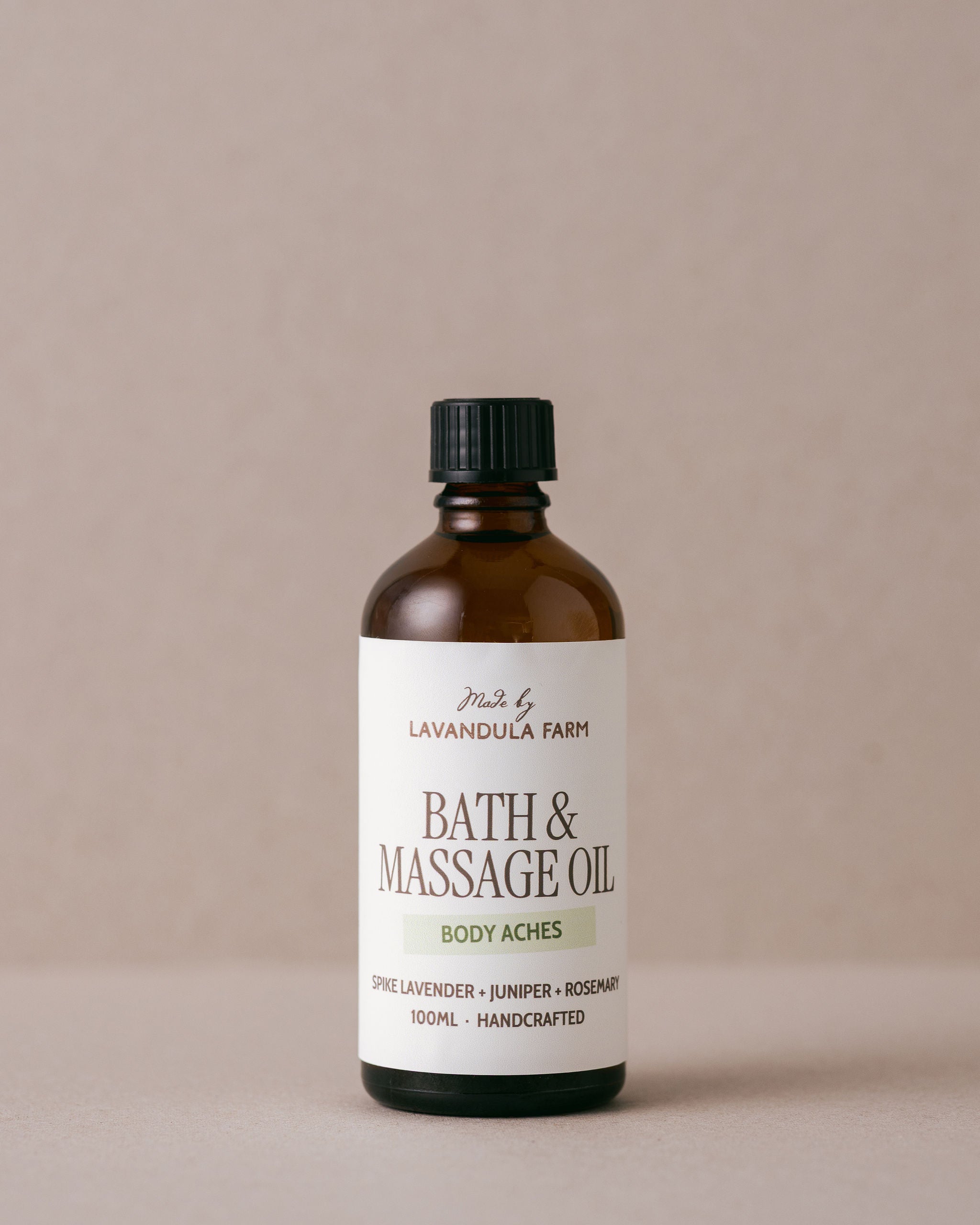 Bath and massage oil for body aches in a glass jar made with natural ingredients at Lavandula Farm