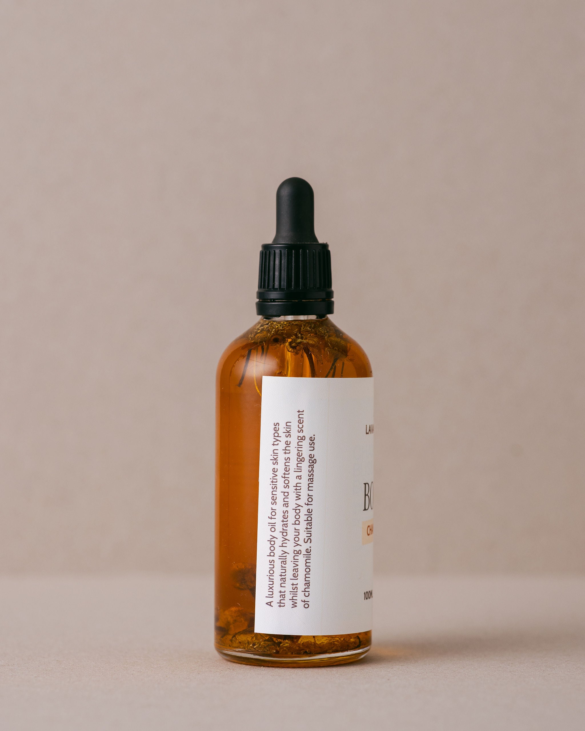 Soothing chamomile body oil in a glass jar with a glass dropper handmade with natural imgredients at Lavandula Farm