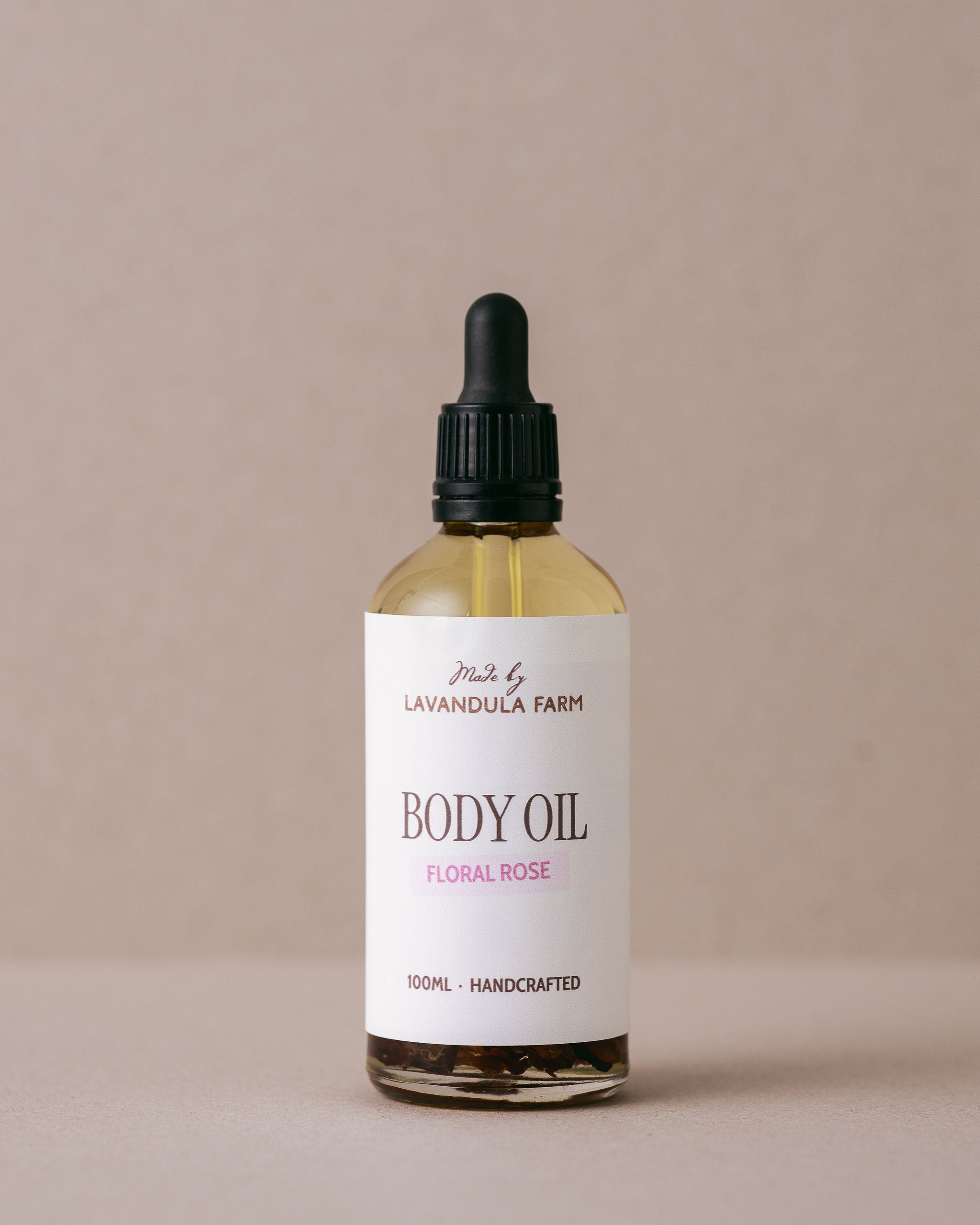 Luxurious floral rose body oil in a glass bottle with a glass dropper handmade at Lavandula Farm