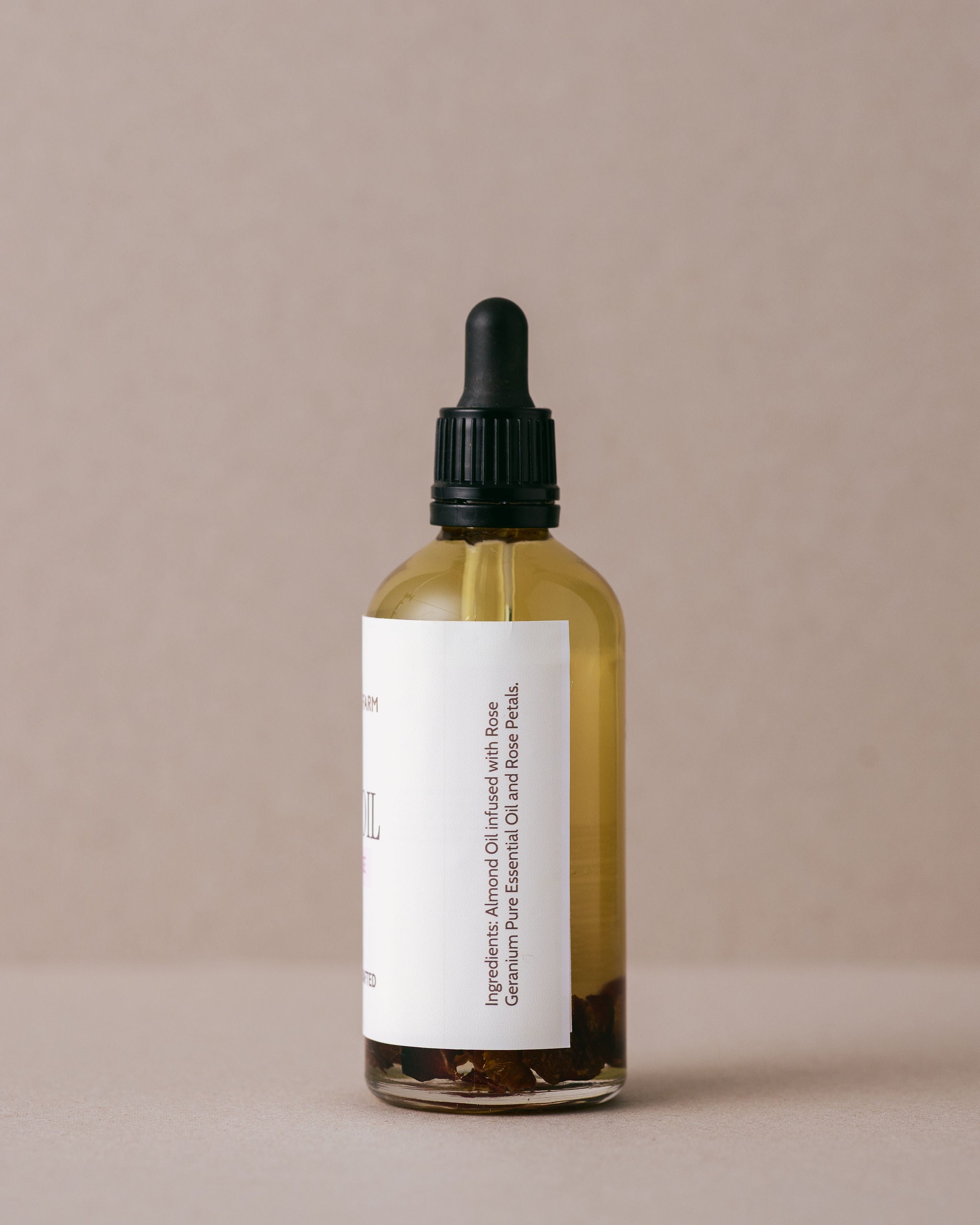 Luxurious floral rose body oil in a glass bottle with a glass dropper handmade at Lavandula Farm