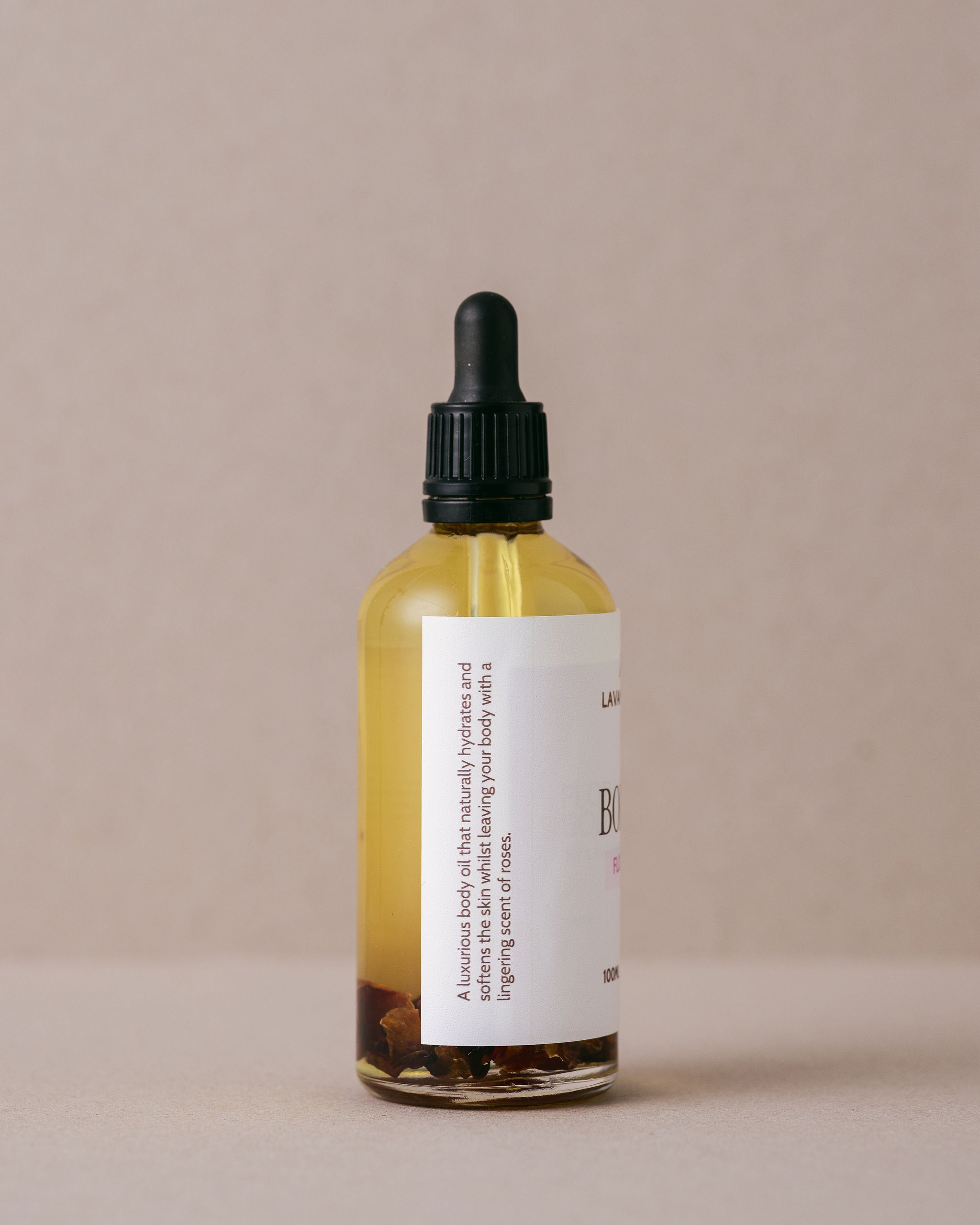 Luxurious floral rose body oil in a glass bottle with a glass dropper handmade at Lavandula Farm