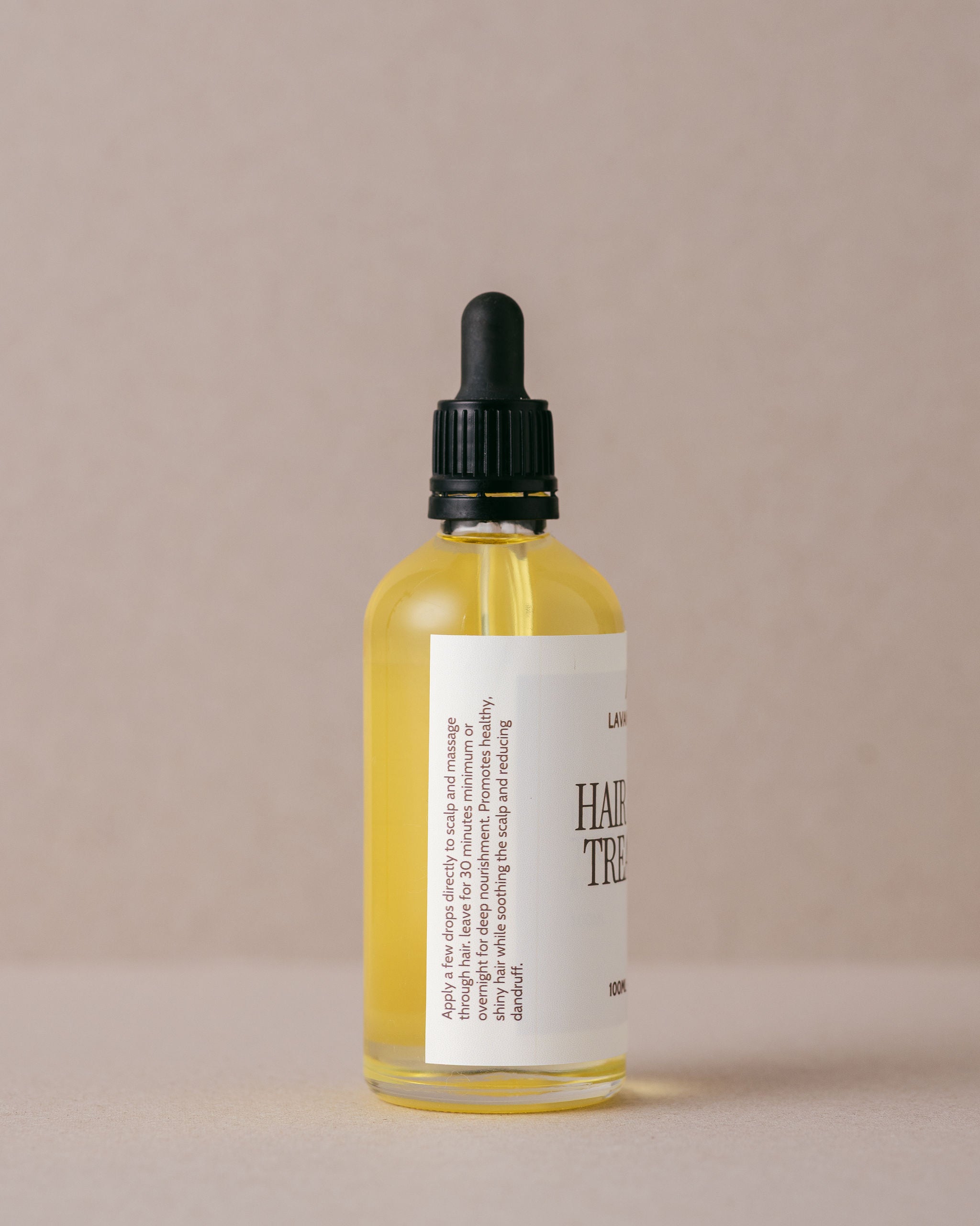 Nourishing hair and scalp treatment oil in a luxurious glass bottle with a glass dropper, handmade at Lavandula Farm