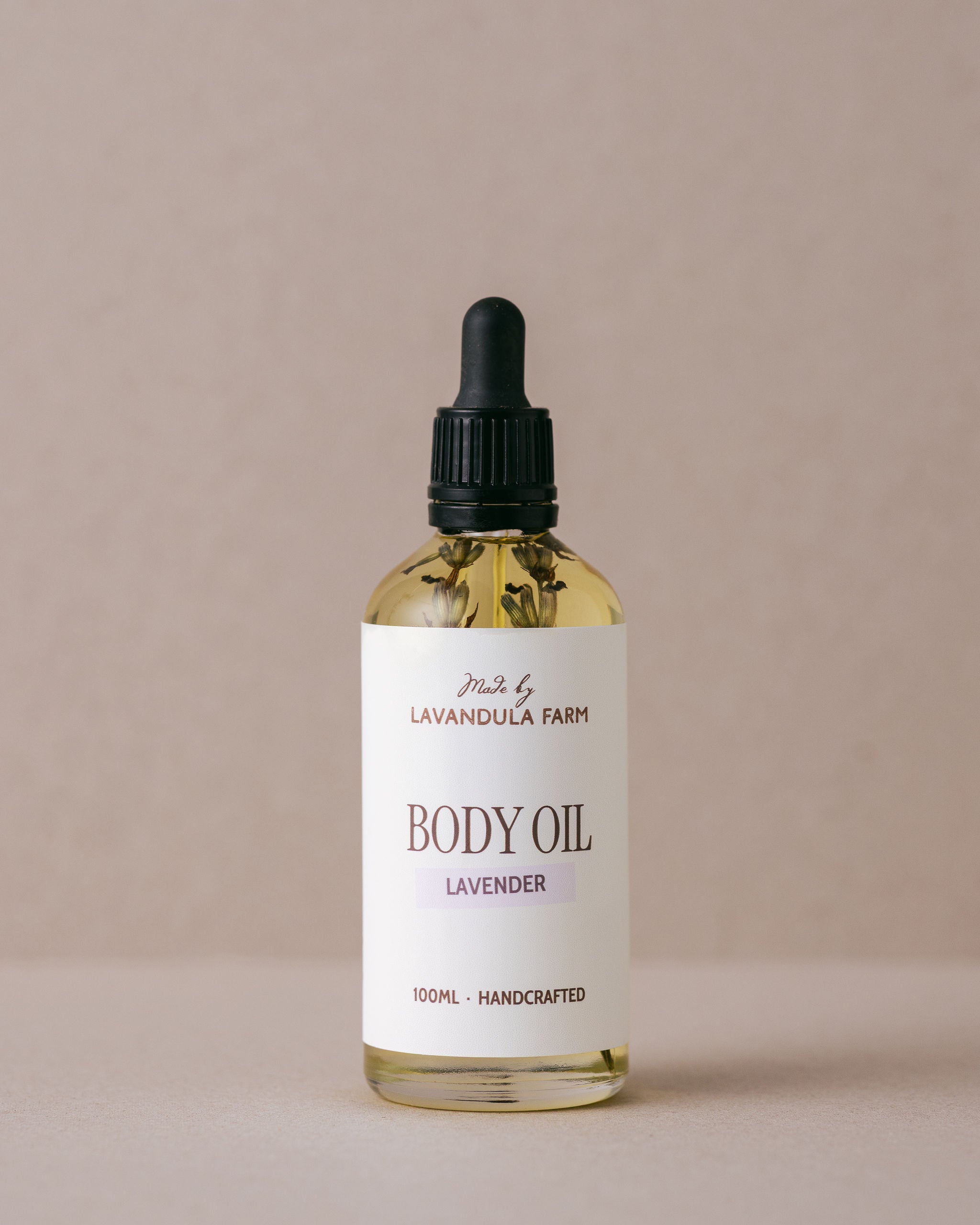 Luxurious lavender body oil in a glass bottle with a glass dropper handmade with natural ingredients at Lavandula Farm