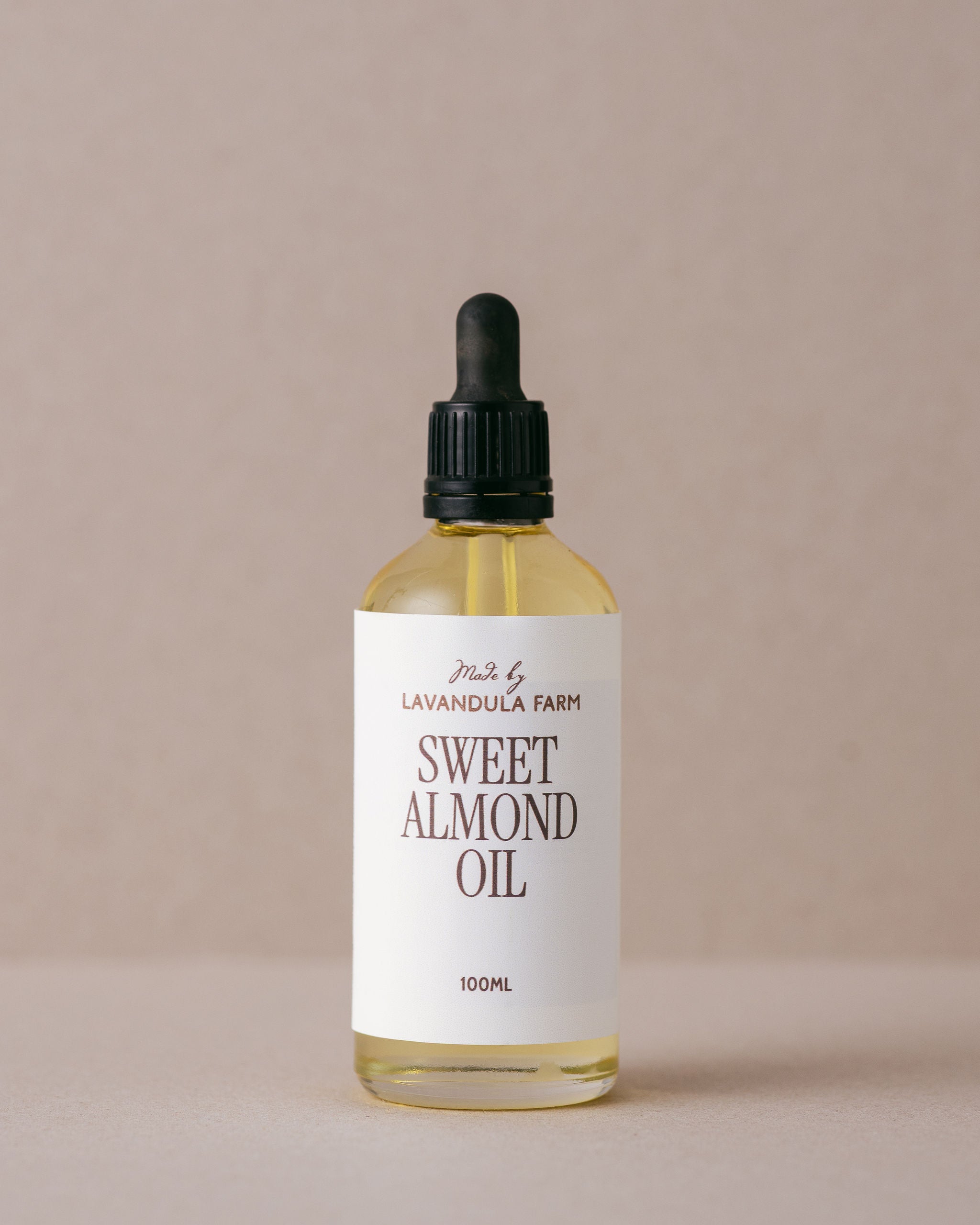 Pure natural sweet almond oil in a glass bottle with glass dropper