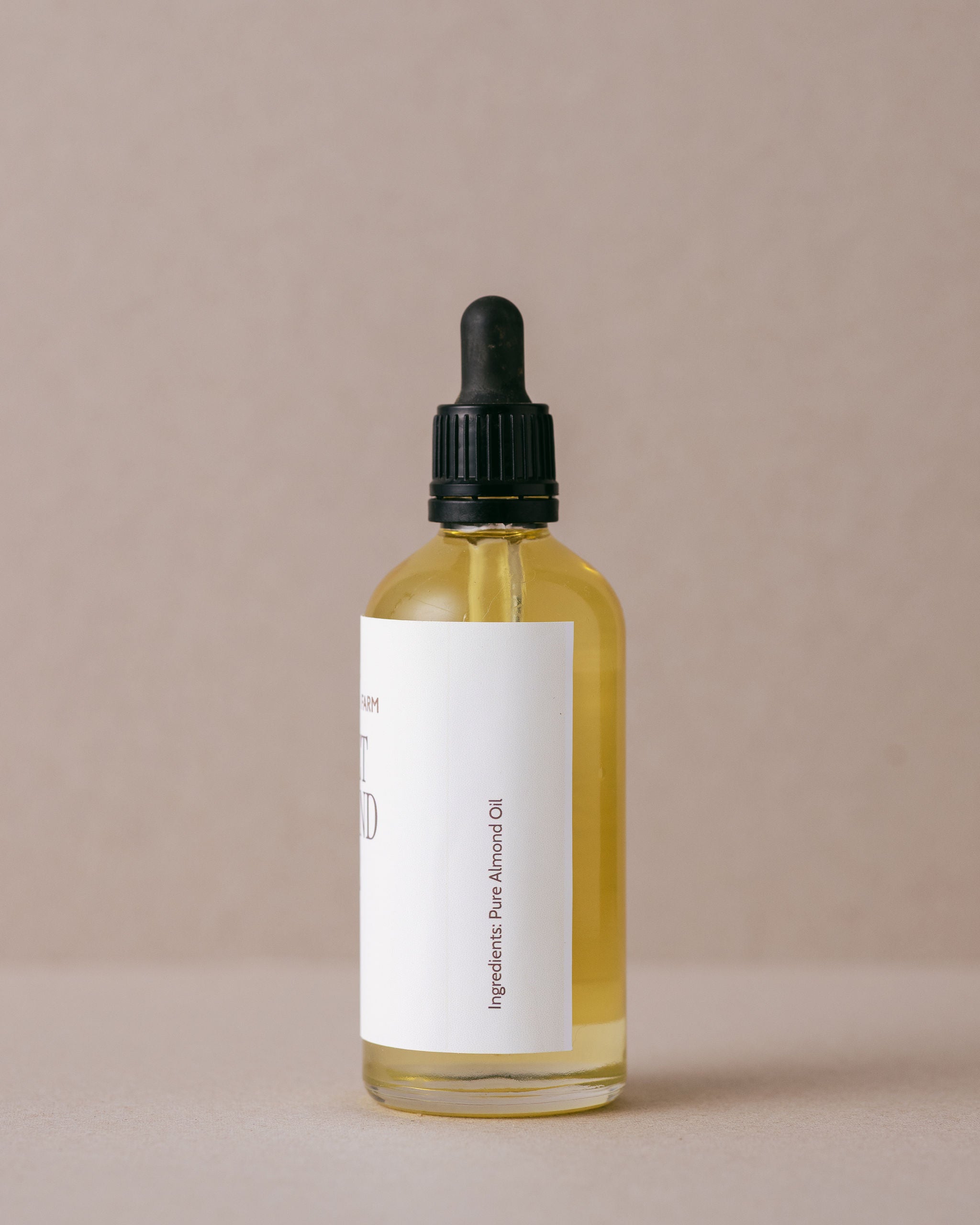 Pure natural sweet almond oil in a glass bottle with glass dropper
