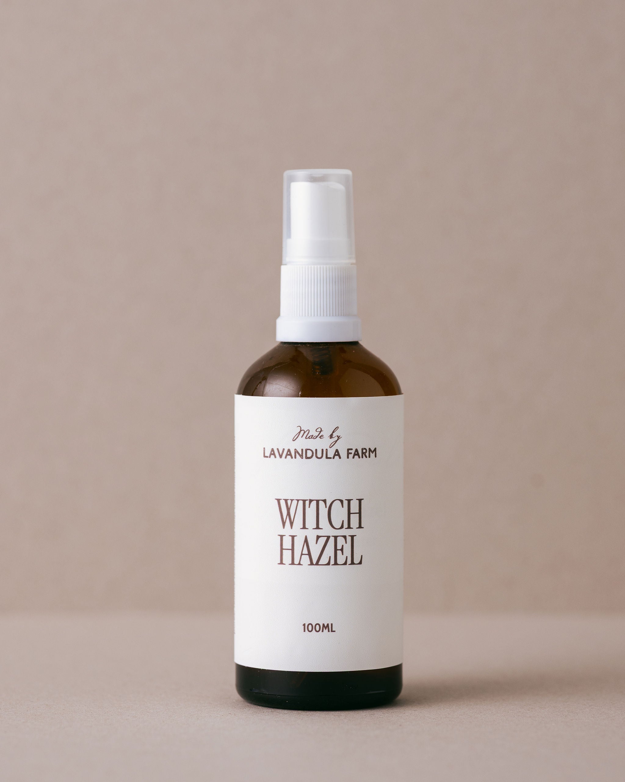 Natural pure witch hazel in a glass jar with a spray top