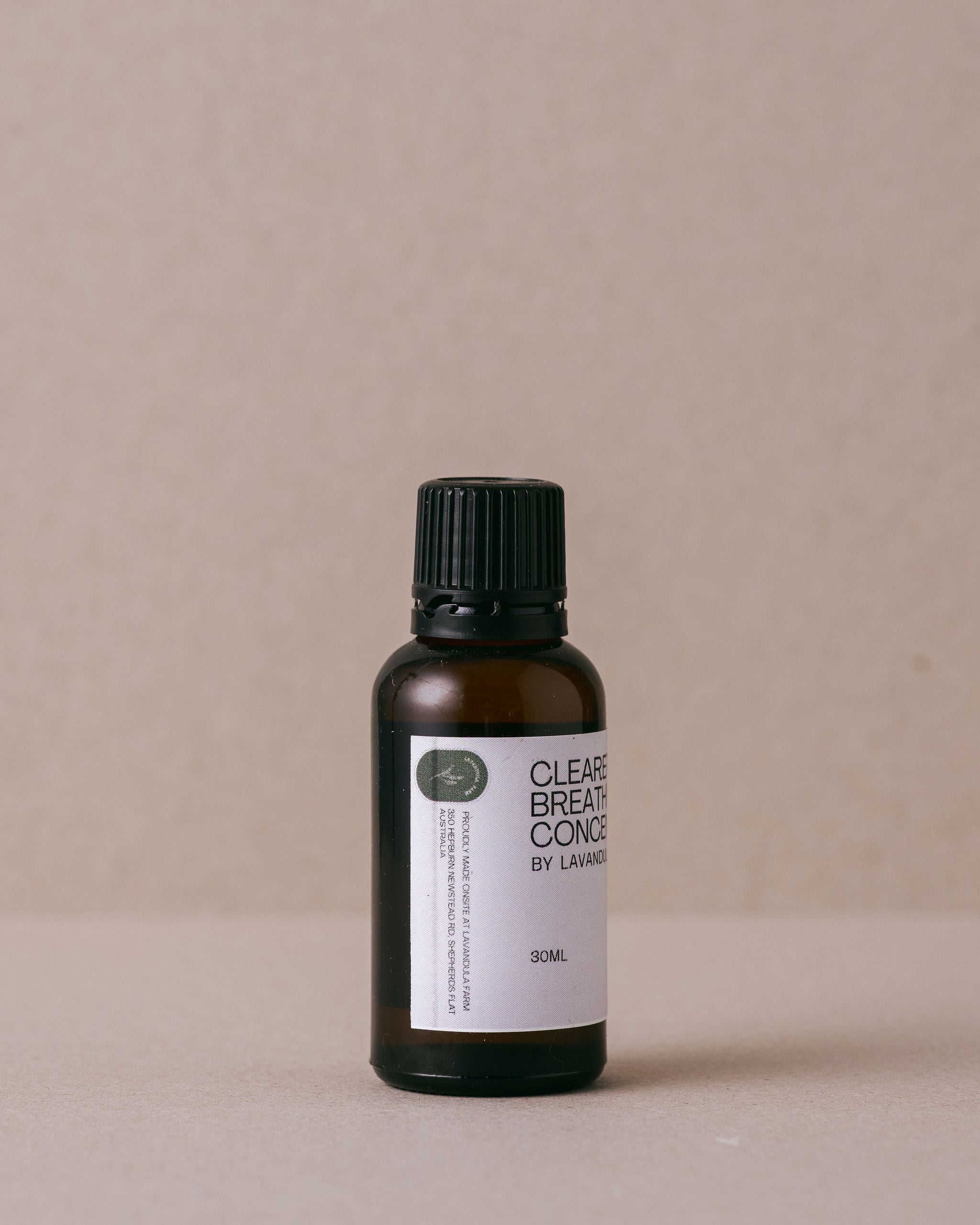 a small glass bottle of clearer breathing concentrrate on a beige background