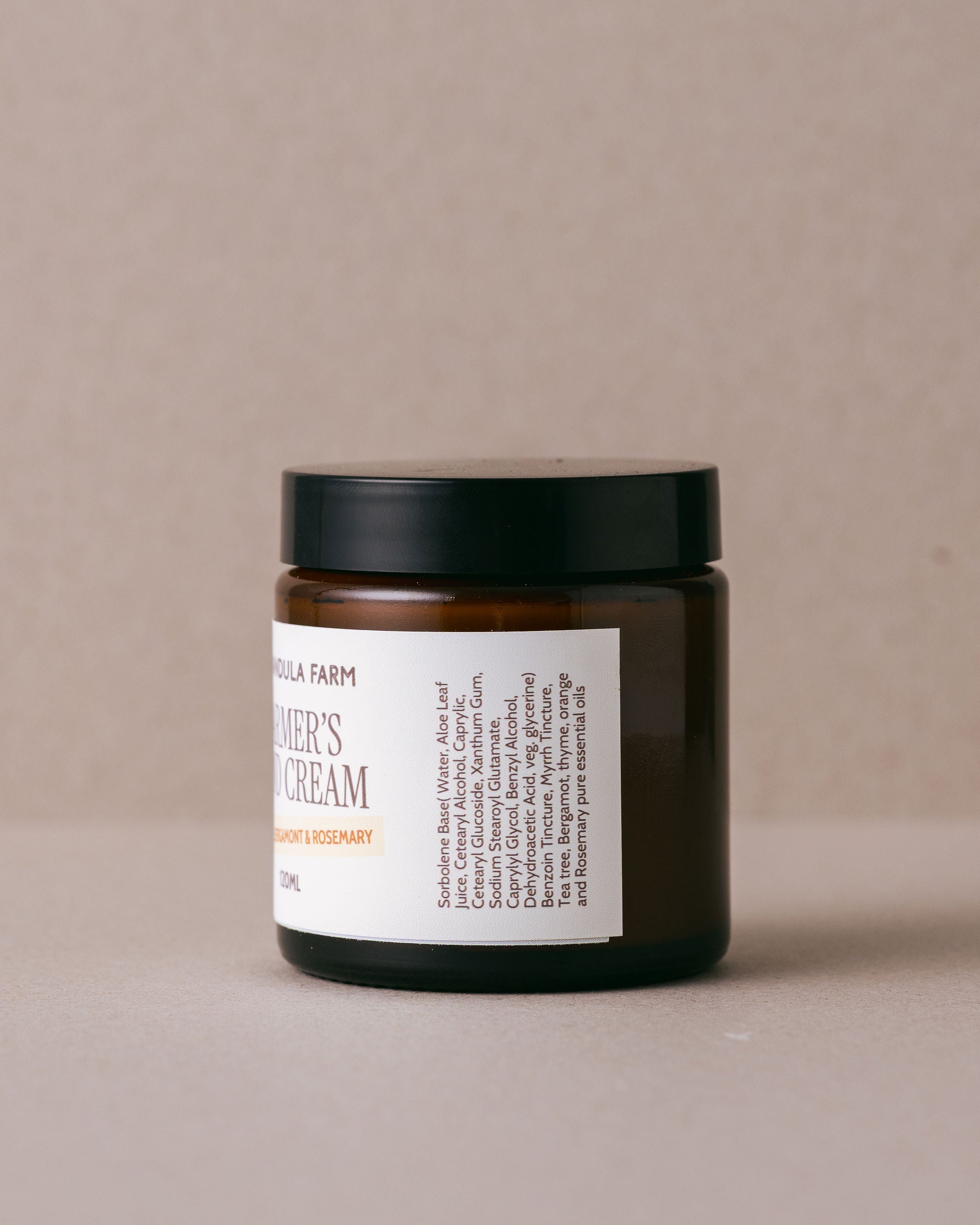 Jar of Farmer's Hand Cream from Lavandula Farm on a beige background