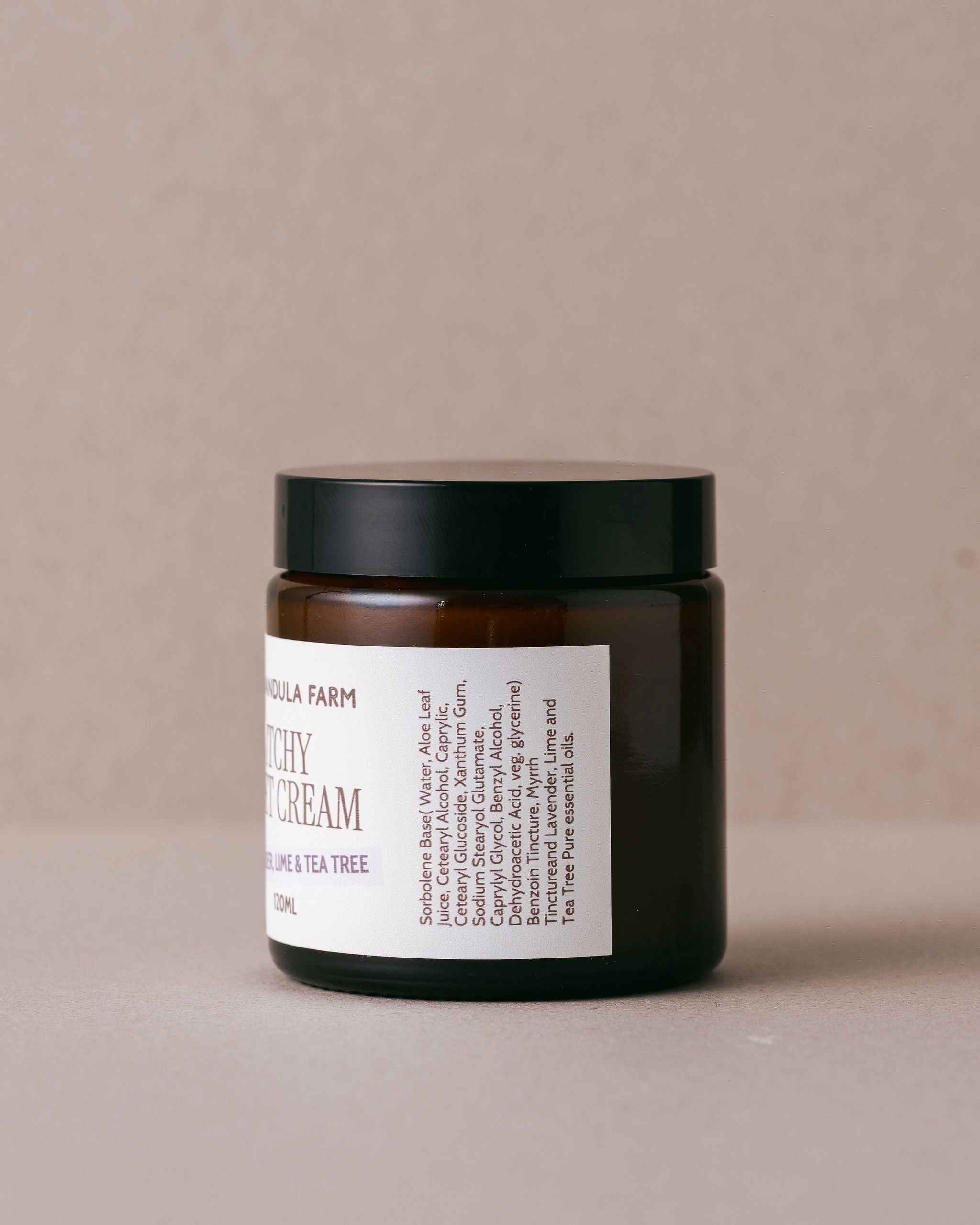 Jar of creamy product with a label on a beige background