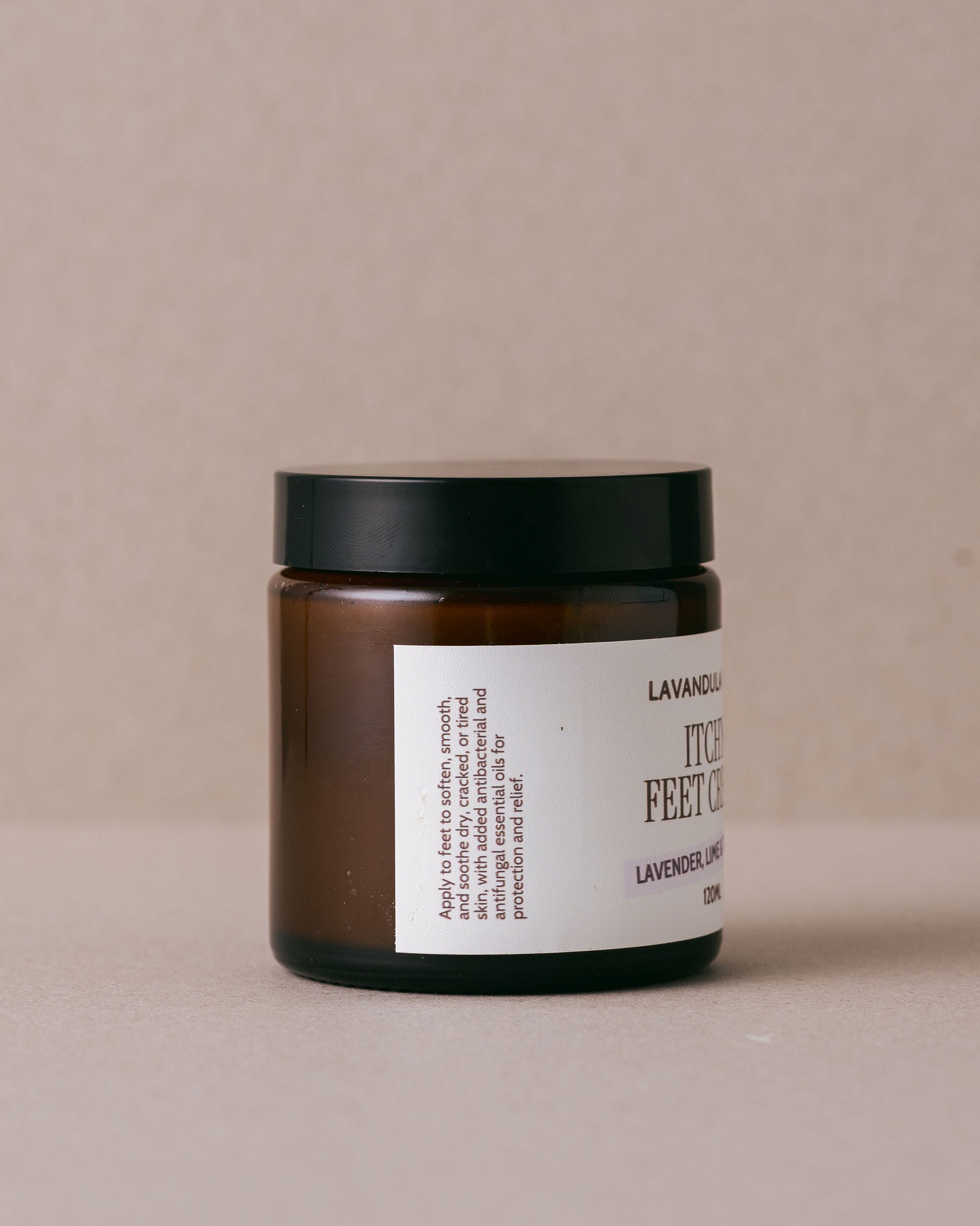 Jar of feet cream with a label on a beige background