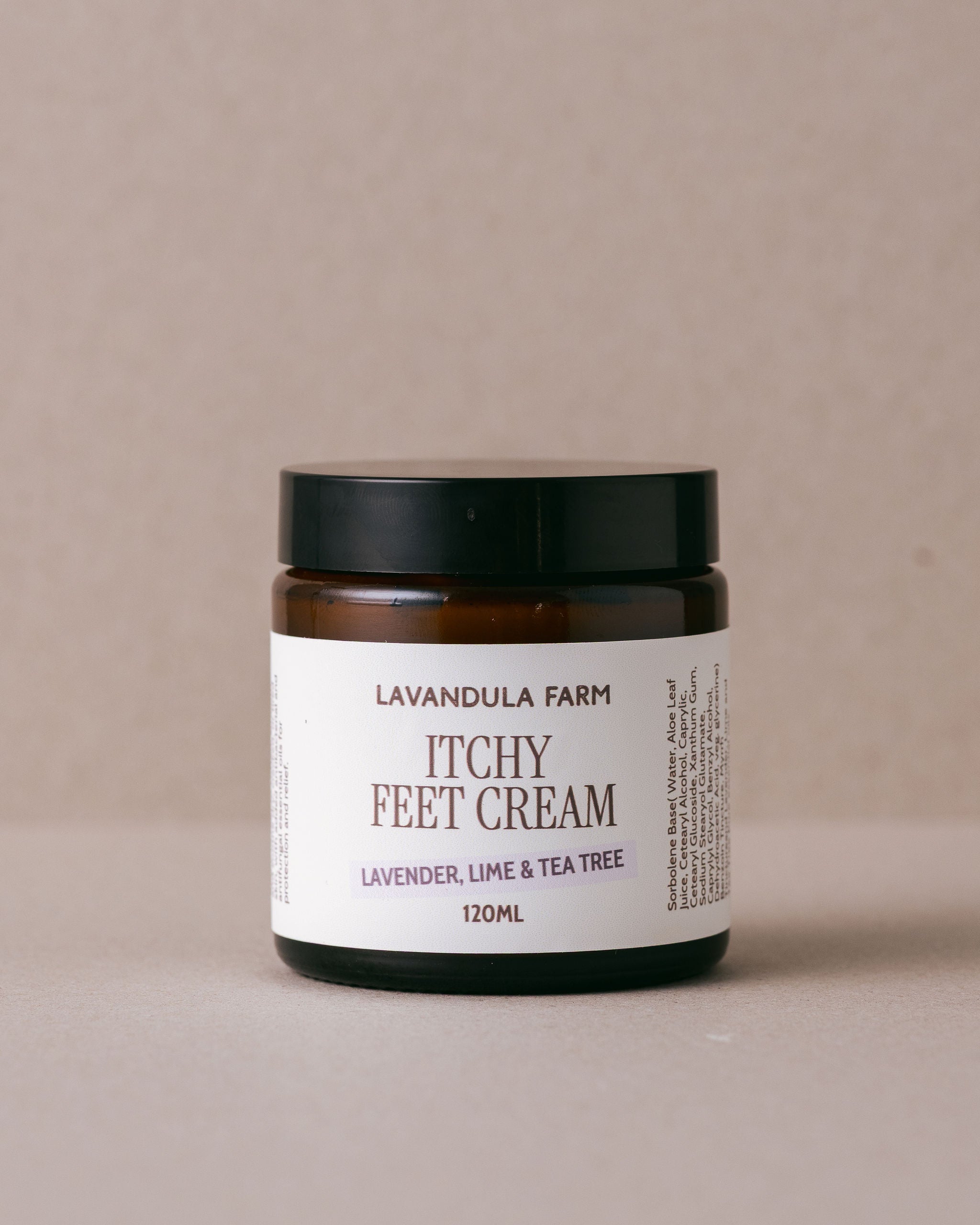 Jar of Lavandula Farm Itchy Feet Cream on a beige background