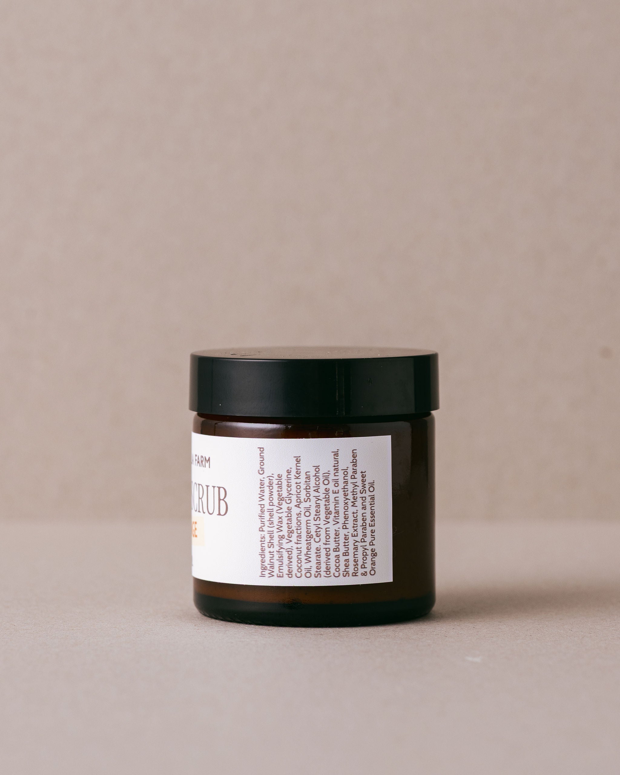 Orange facial scrub in a glass jar handmade with natural ingredients at Lavandula Farm