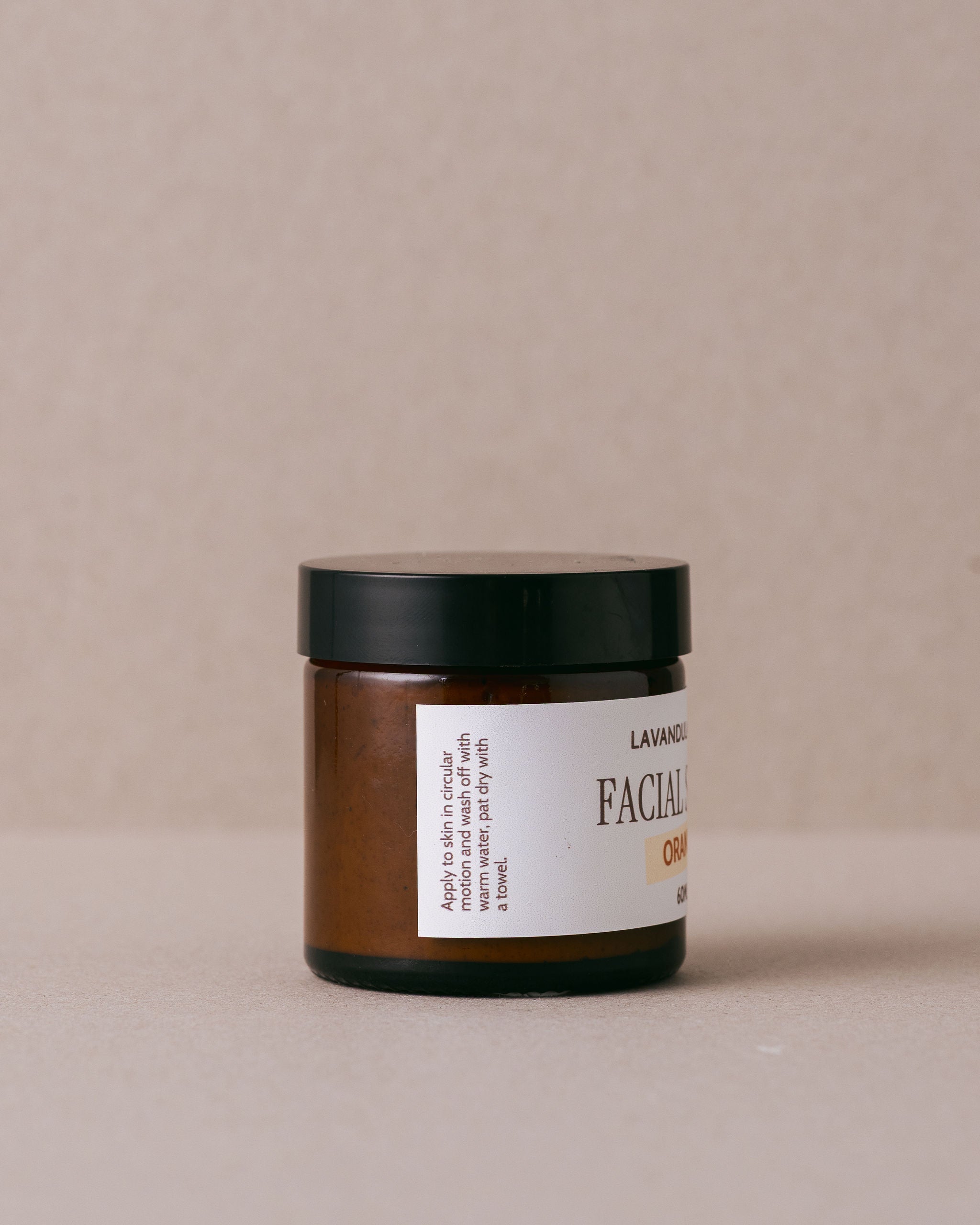 Orange facial scrub in a glass jar handmade with natural ingredients at Lavandula Farm