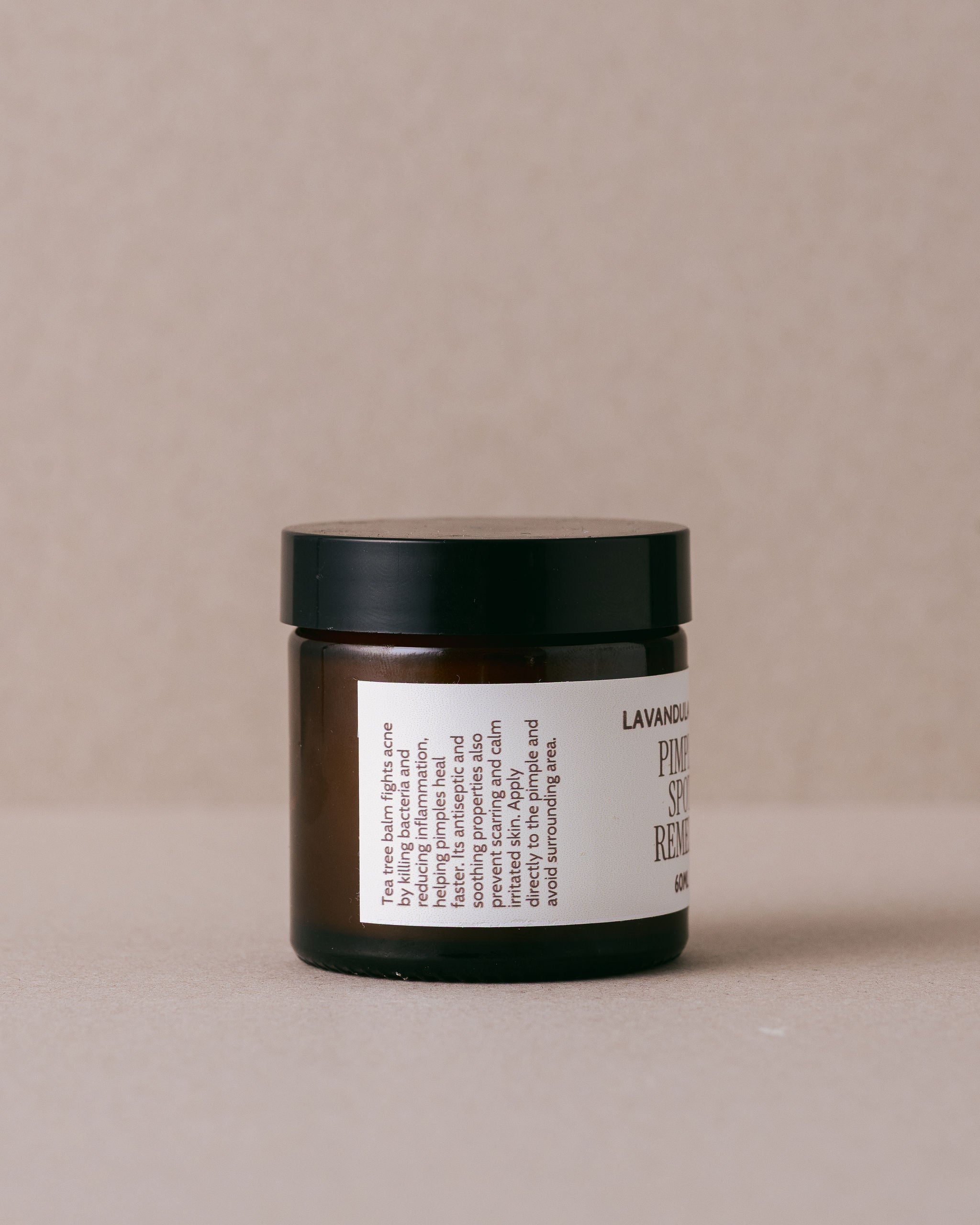 Jar of 'Pimple Spot Remedy' from Lavandula Farm on a beige background