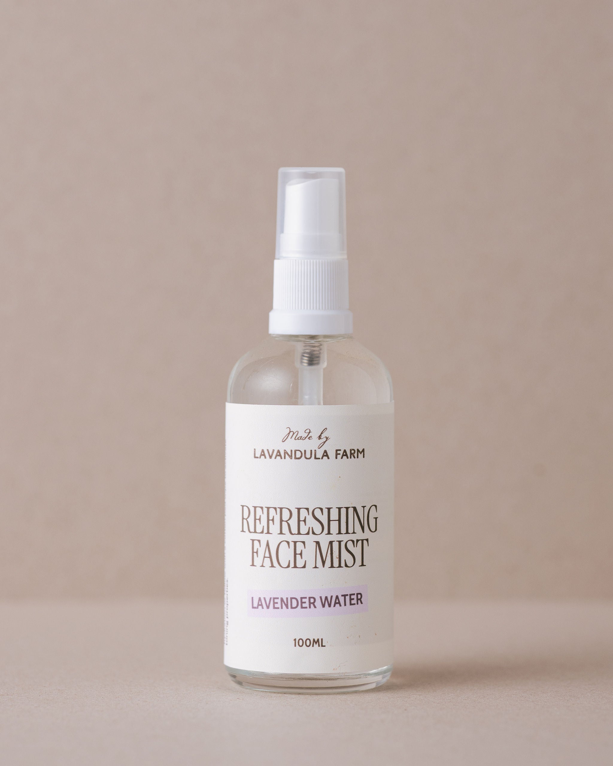 Bottle of Lavender Farm refreshing face mist on a beige background