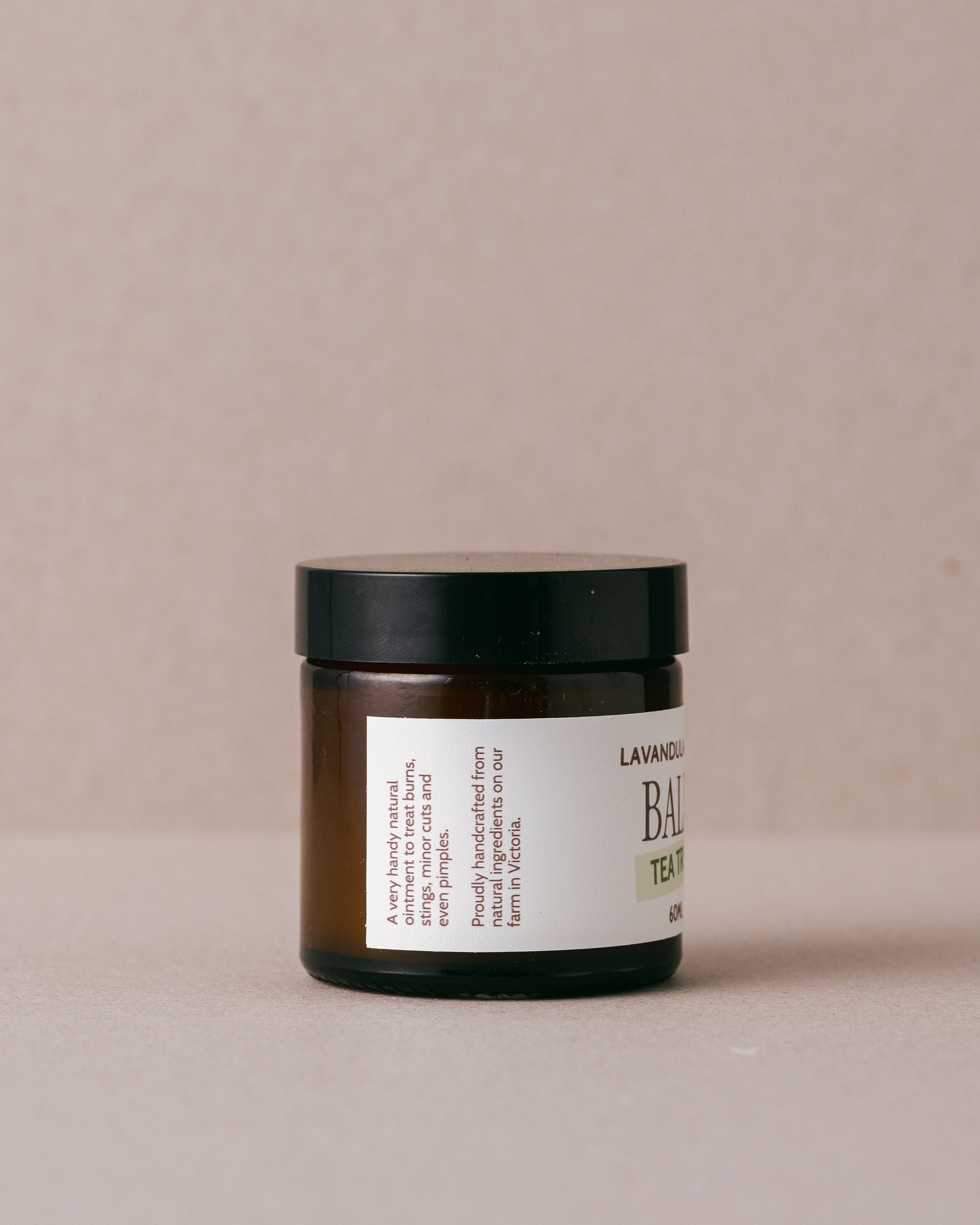 tea tree balm in a small glass jar made with natural ingredients at Lavandula Farm