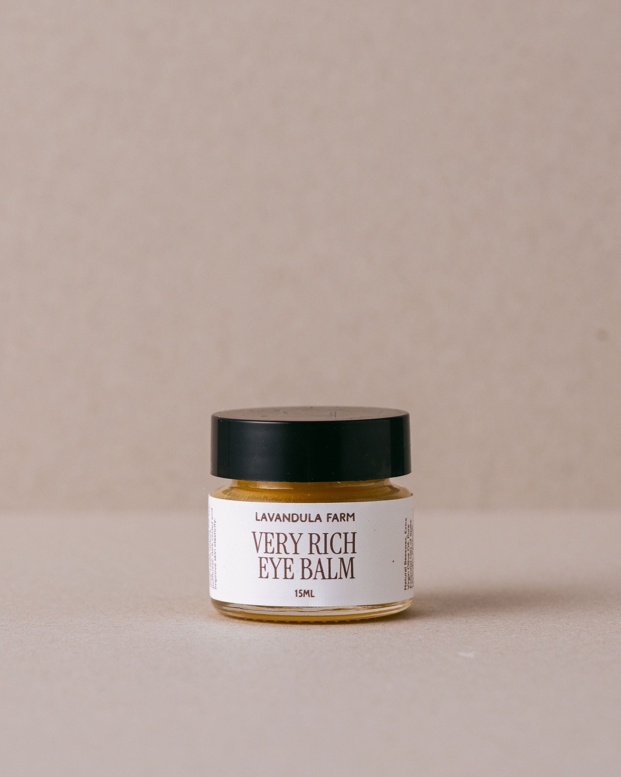 Jar of 'Very Rich Eye Balm' from Lavandula Farm on a beige background
