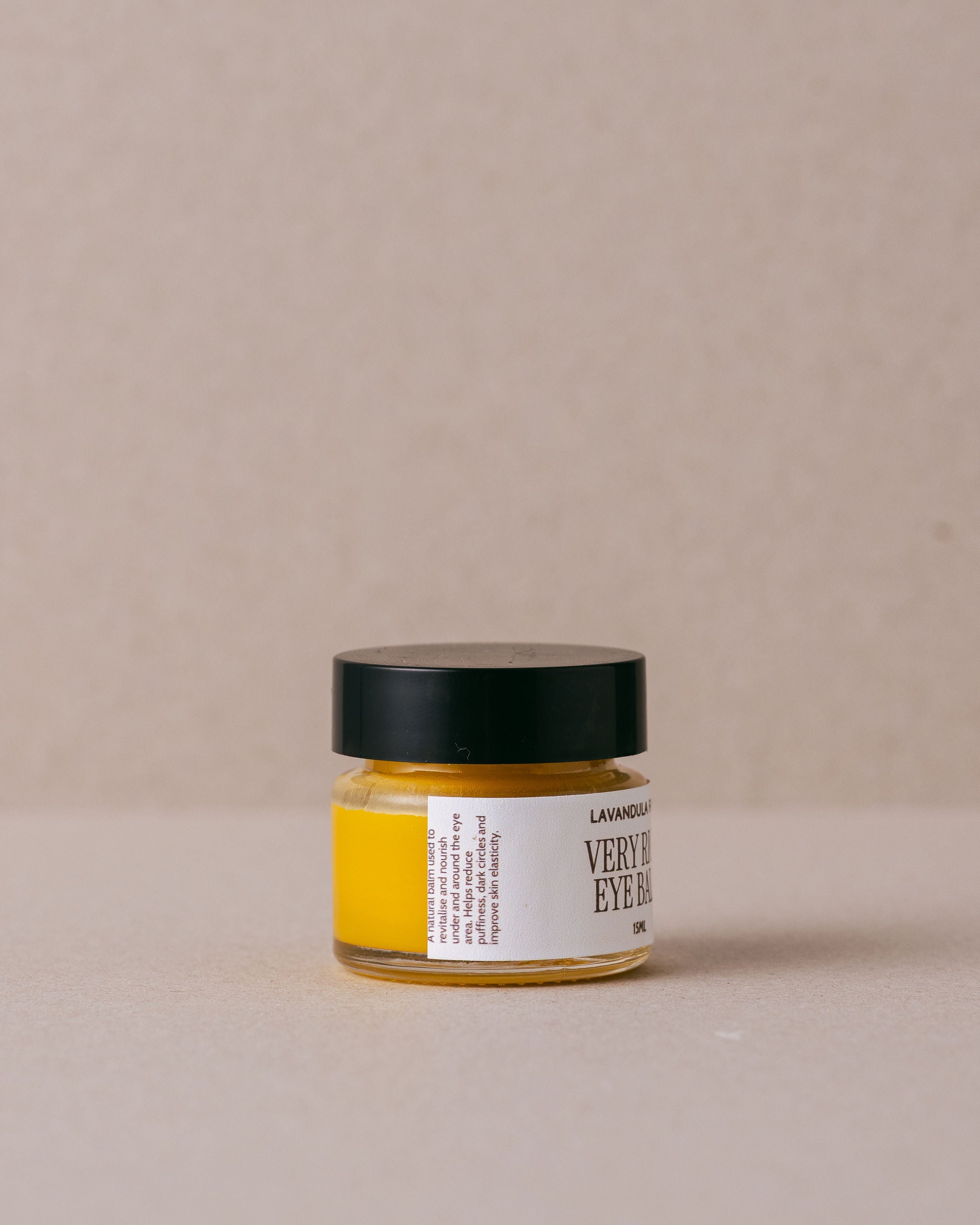 Jar of 'Very Rich Eye Balm' from Lavandula Farm on a beige background