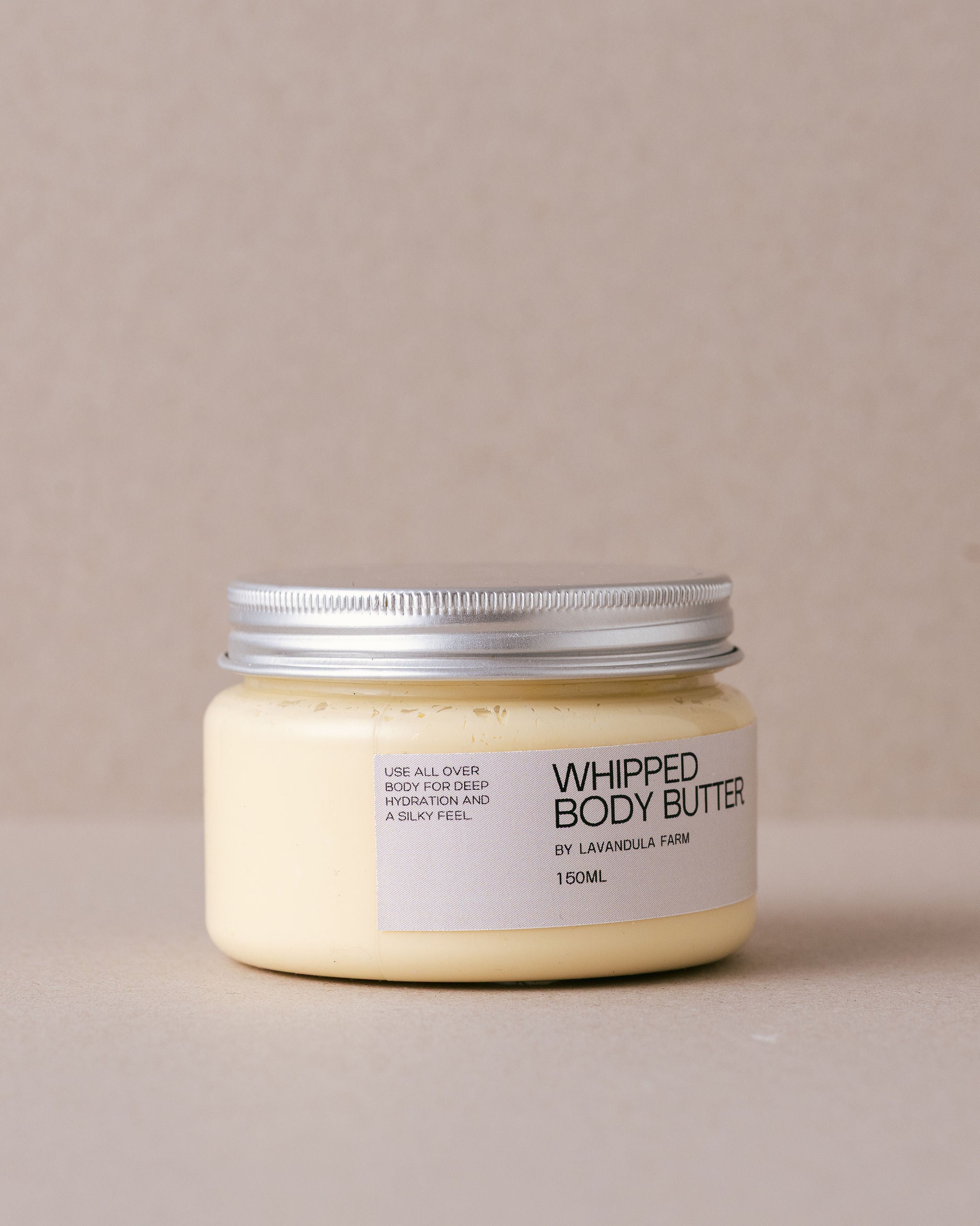 tub of whipped body butter made by Lavandula Farm on a beige background