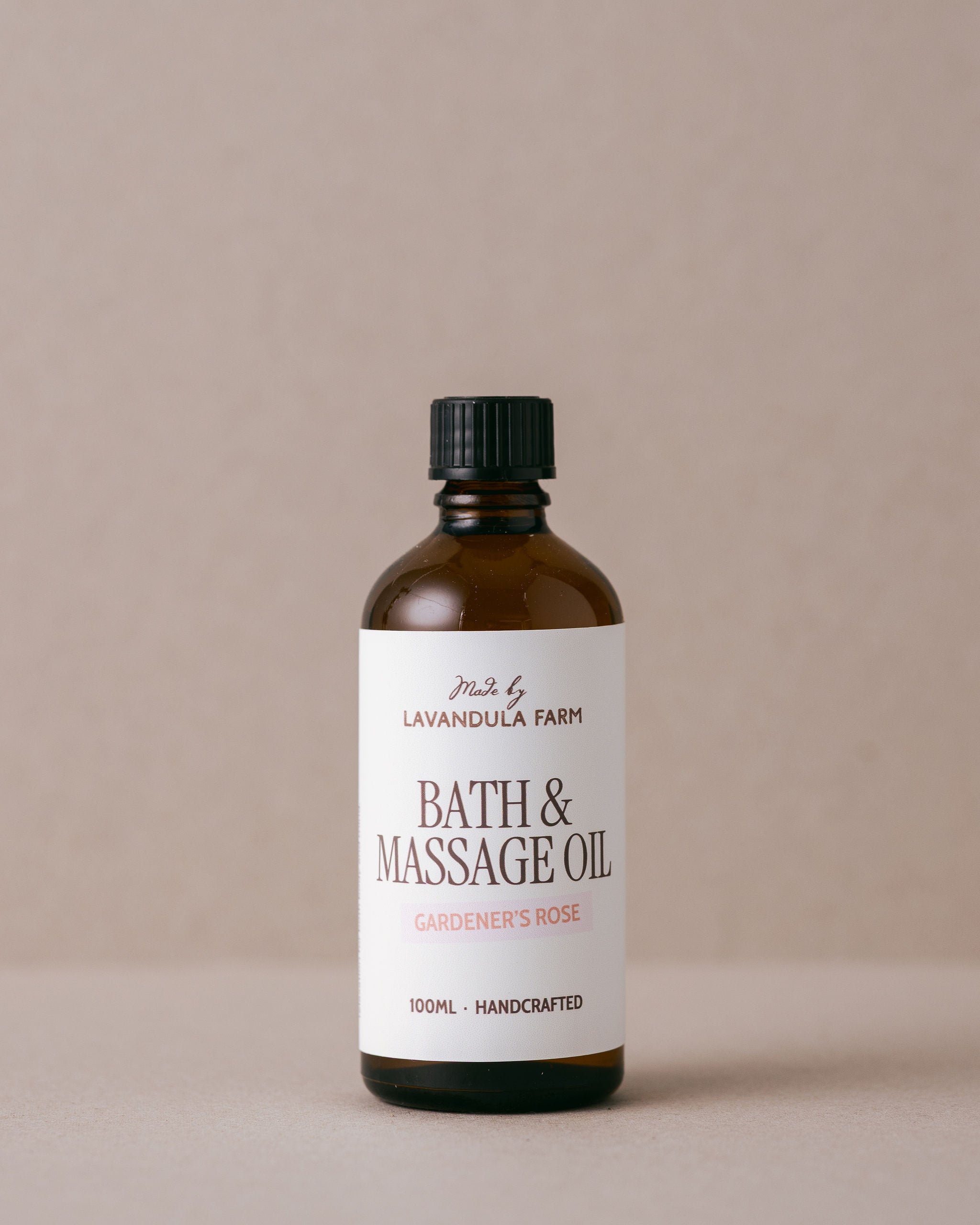 Lavender and rose geranium bath and massage oil in a glass bottle handmade with natural ingredients at Lavandula Farm