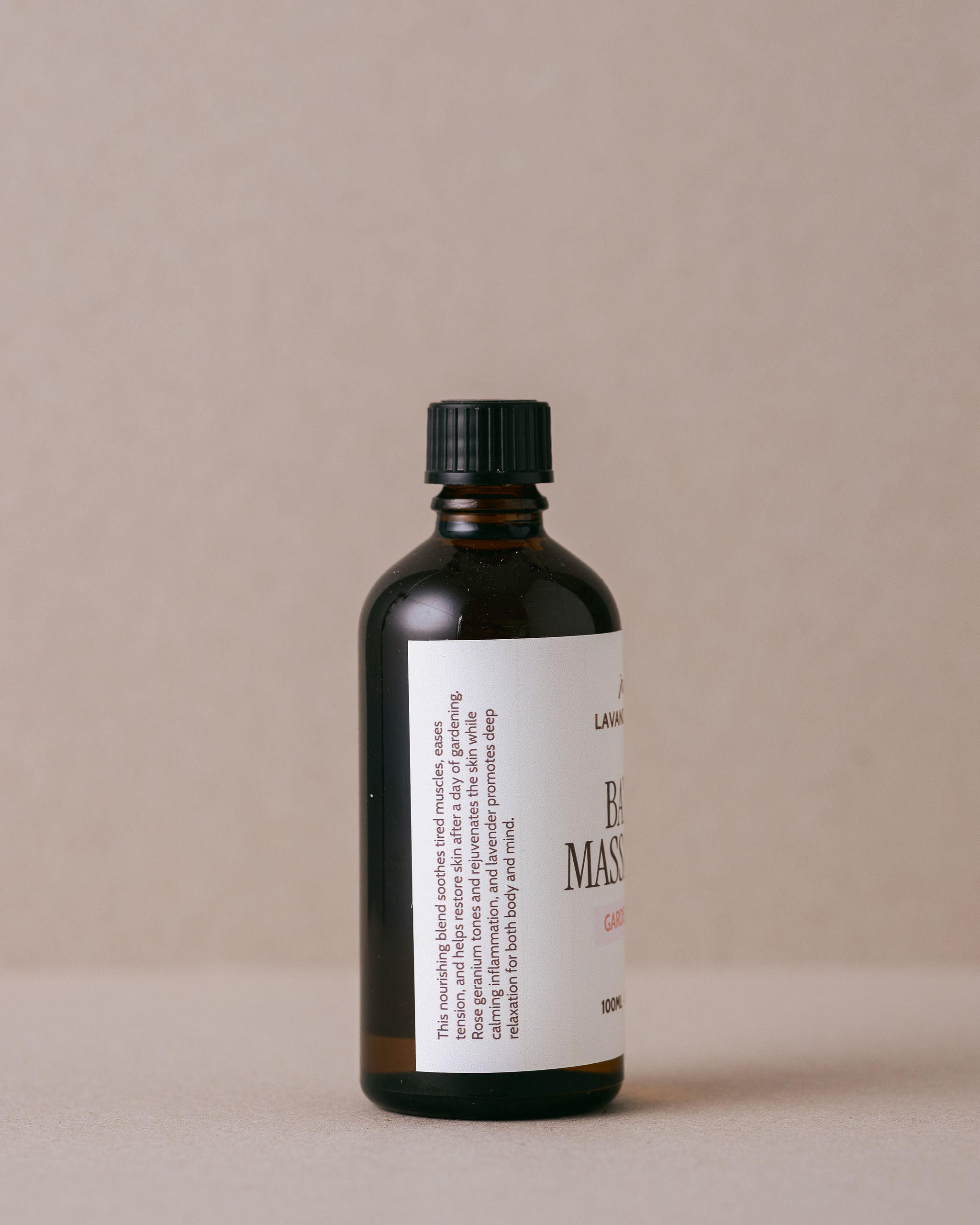 Lavender and rose geranium bath and massage oil in a glass bottle handmade with natural ingredients at Lavandula Farm