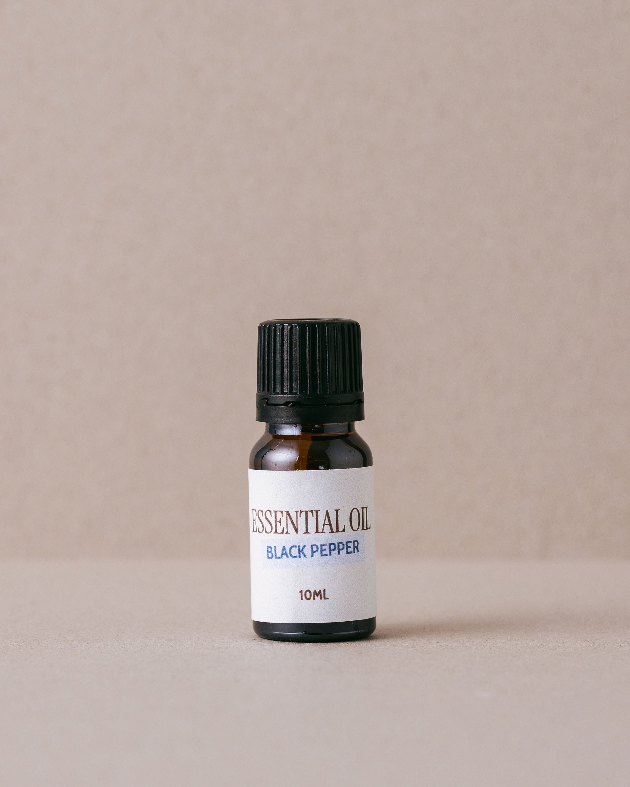 Black Pepper pure essential oil in small glass jar