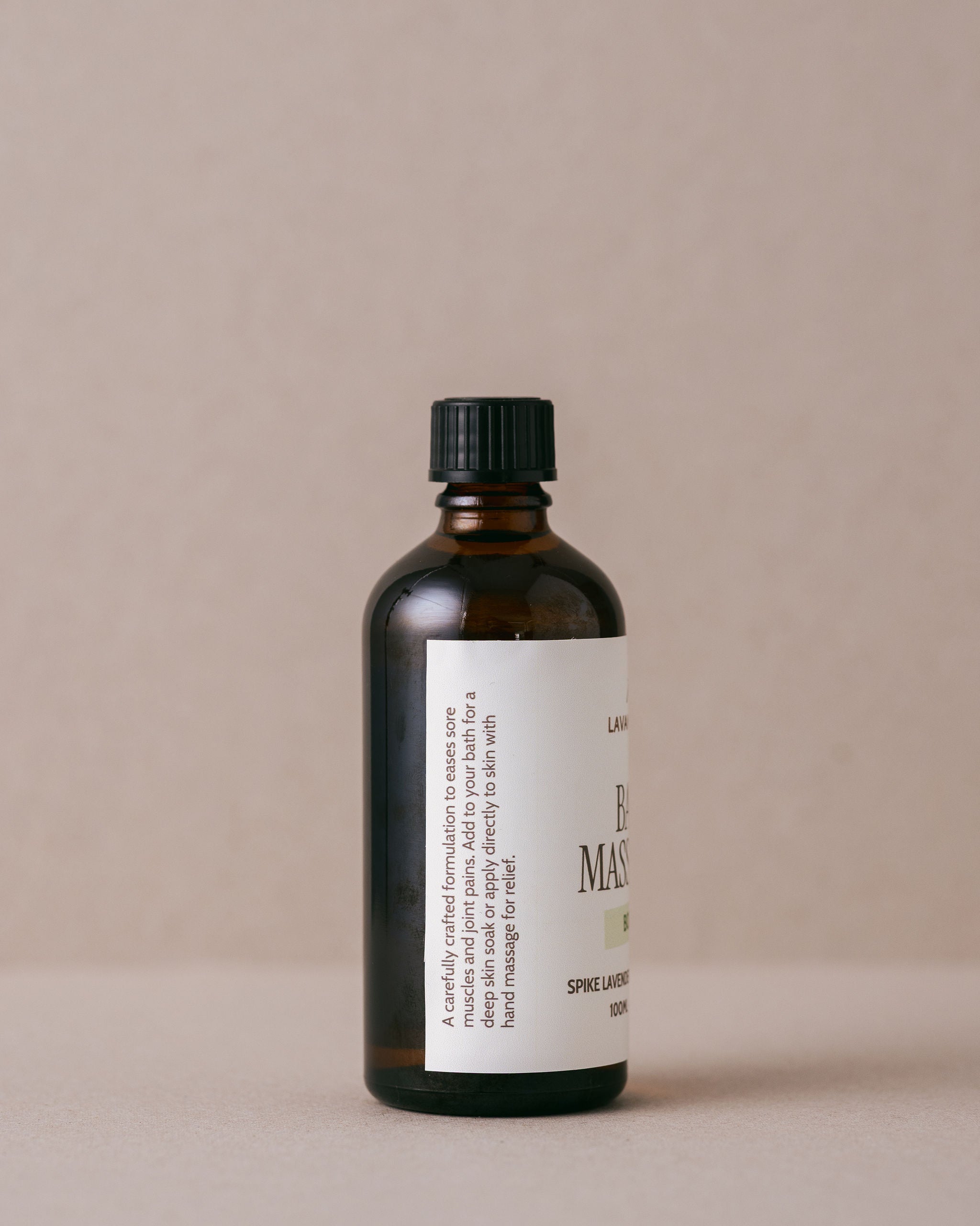 Bath and massage oil for body aches in a glass jar made with natural ingredients at Lavandula Farm