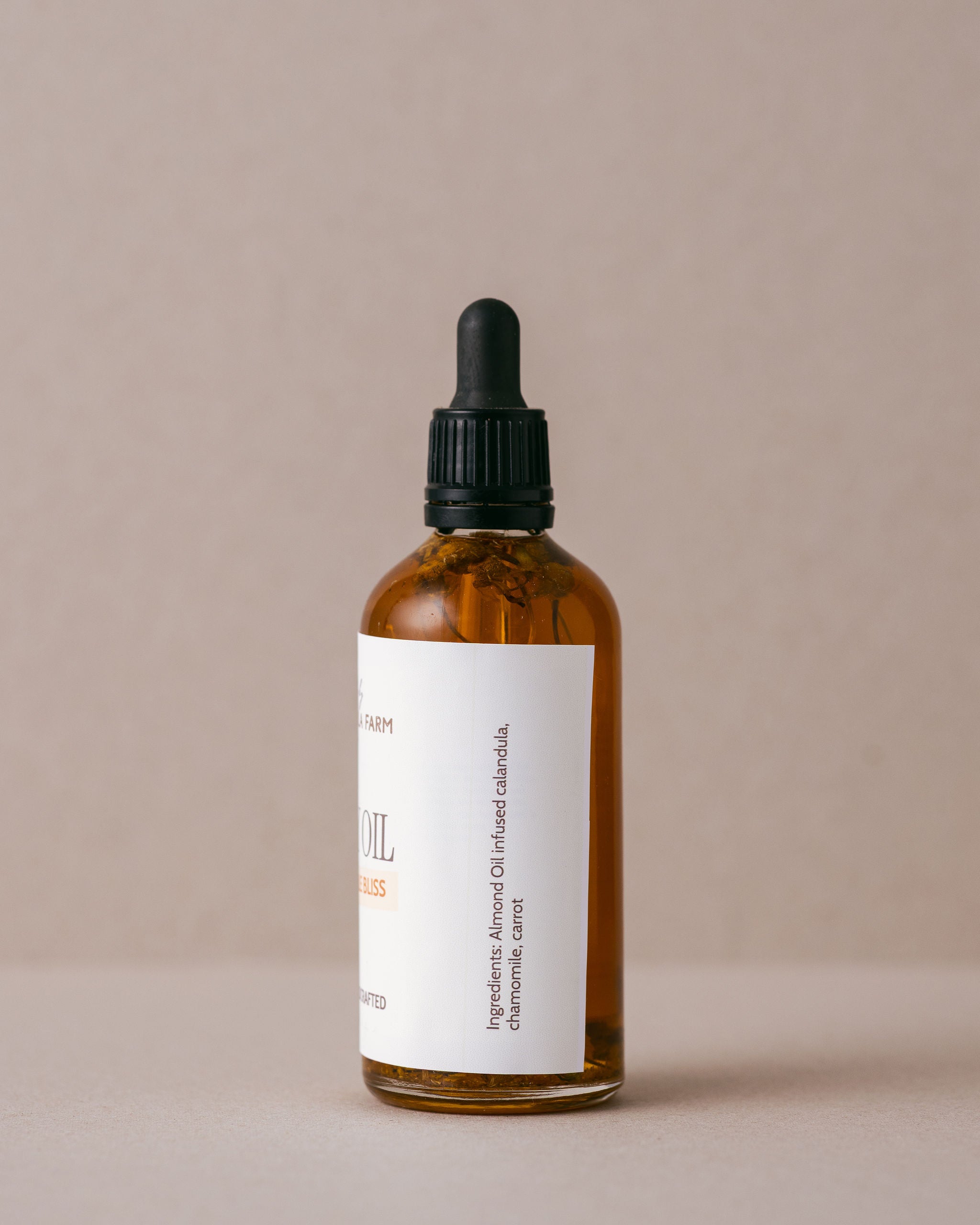 Soothing chamomile body oil in a glass jar with a glass dropper handmade with natural imgredients at Lavandula Farm