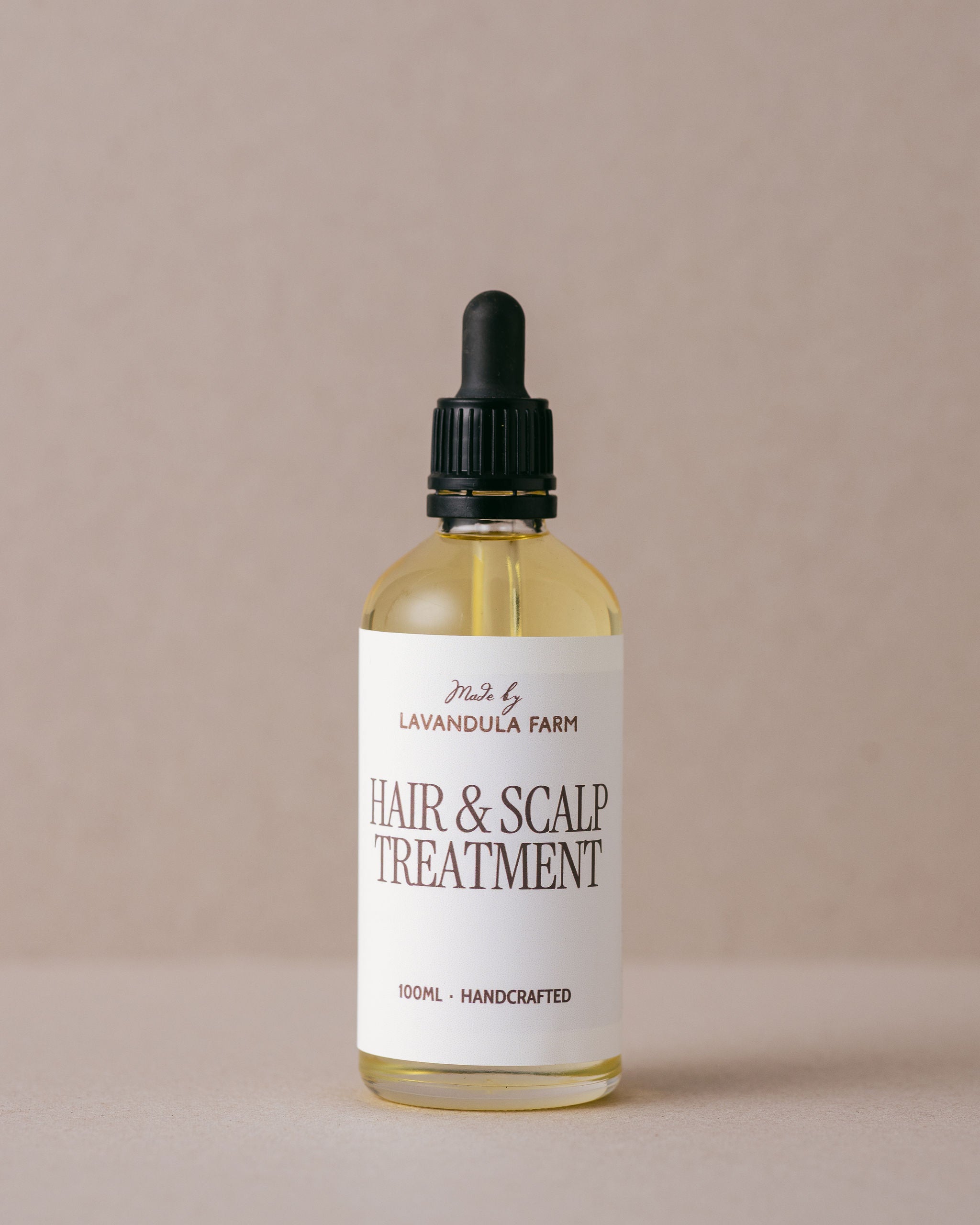Nourishing hair and scalp treatment oil in a luxurious glass bottle with a glass dropper, handmade at Lavandula Farm