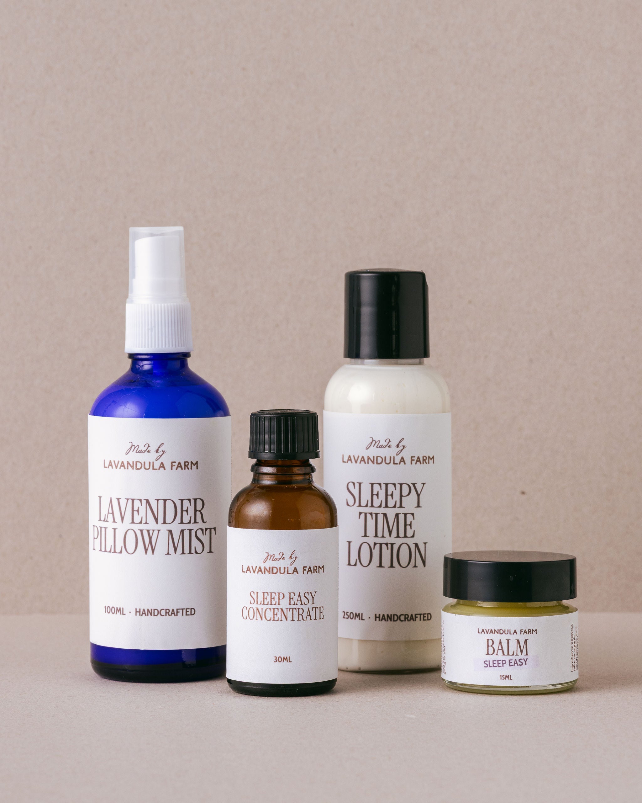 Collection of Lavandula Farm products including pillow mist, lotion, and balm on a beige background