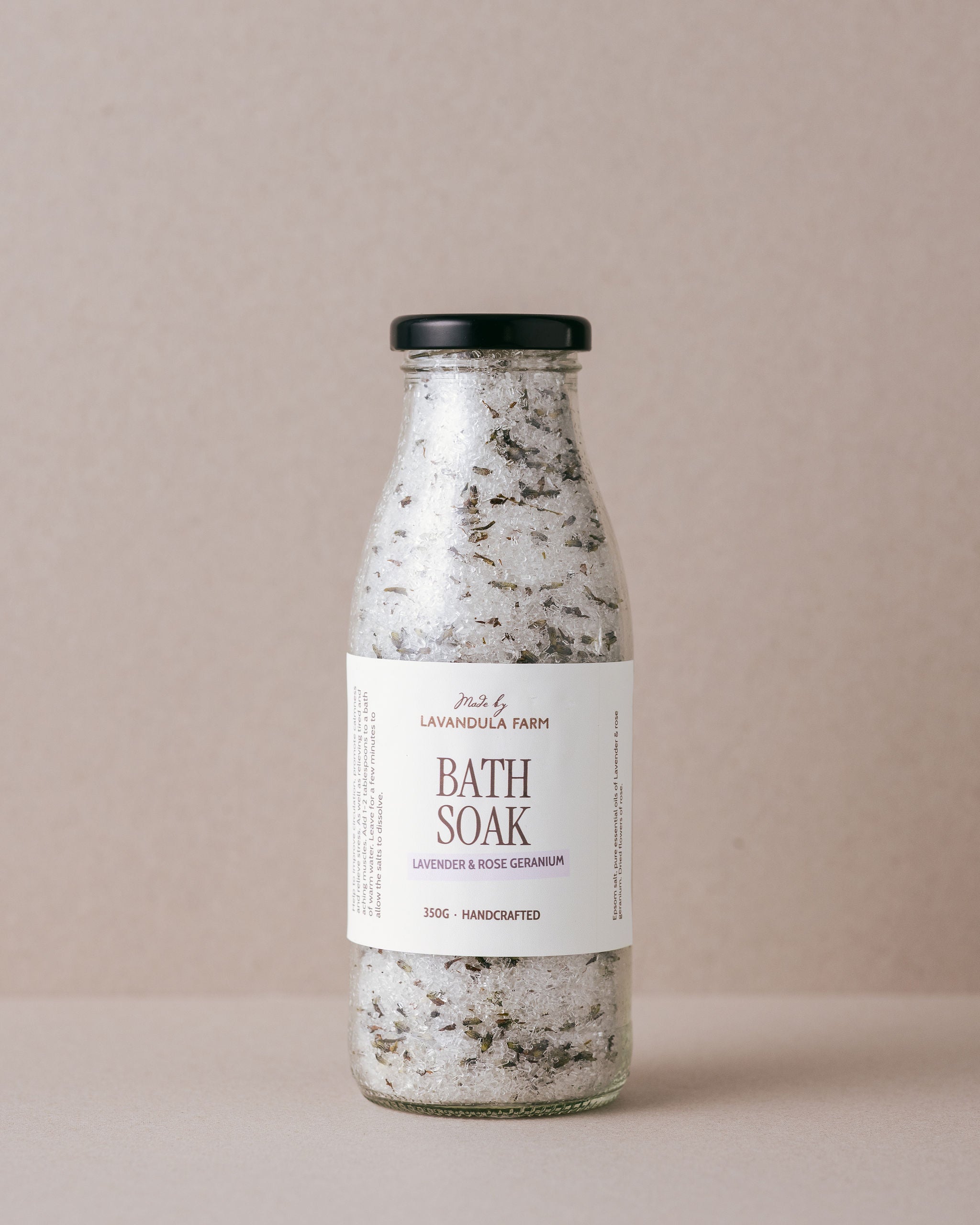 Lavender and Rose Geranium bath soak in a glass bottle