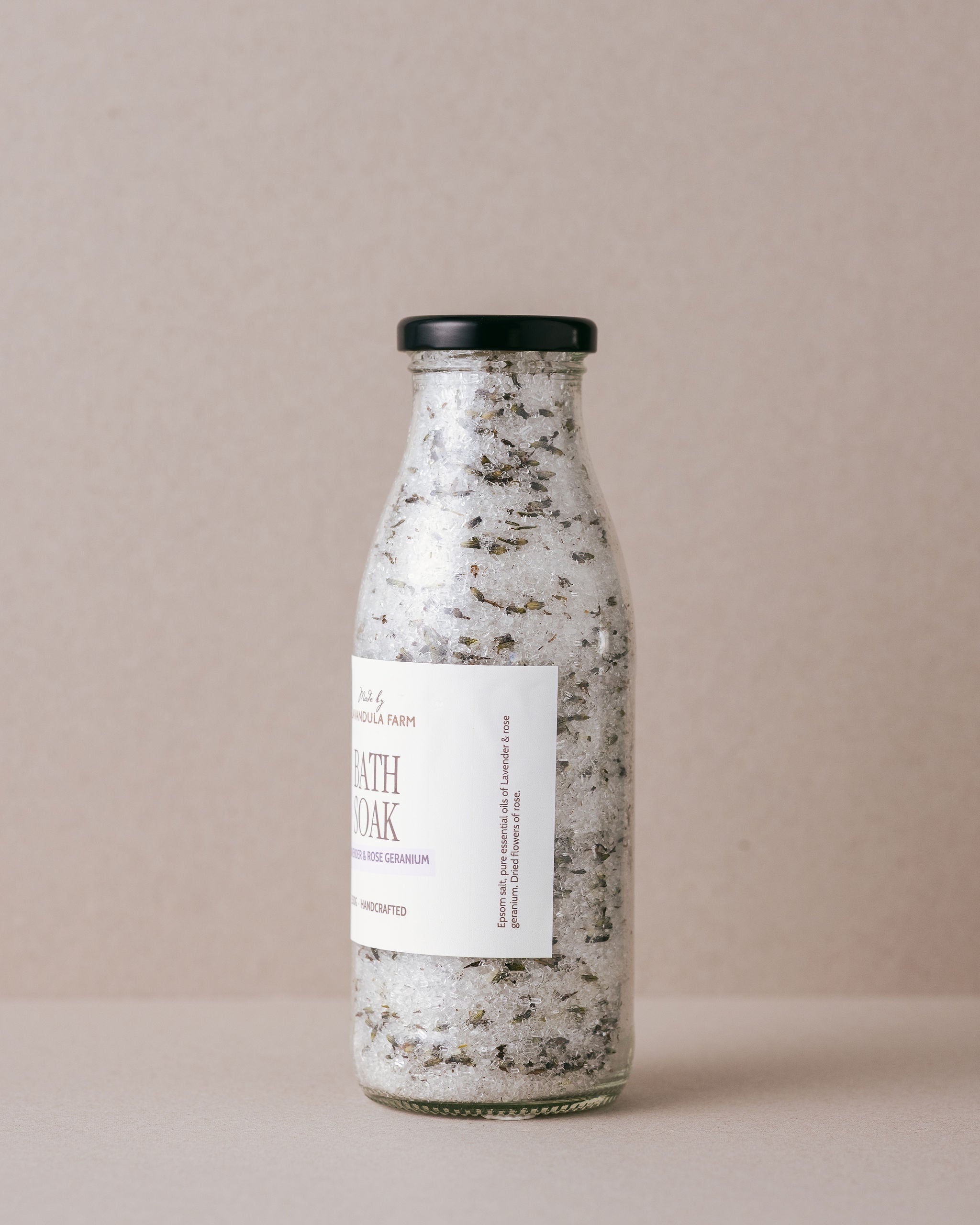 Lavender and Rose Geranium bath soak in a glass bottle