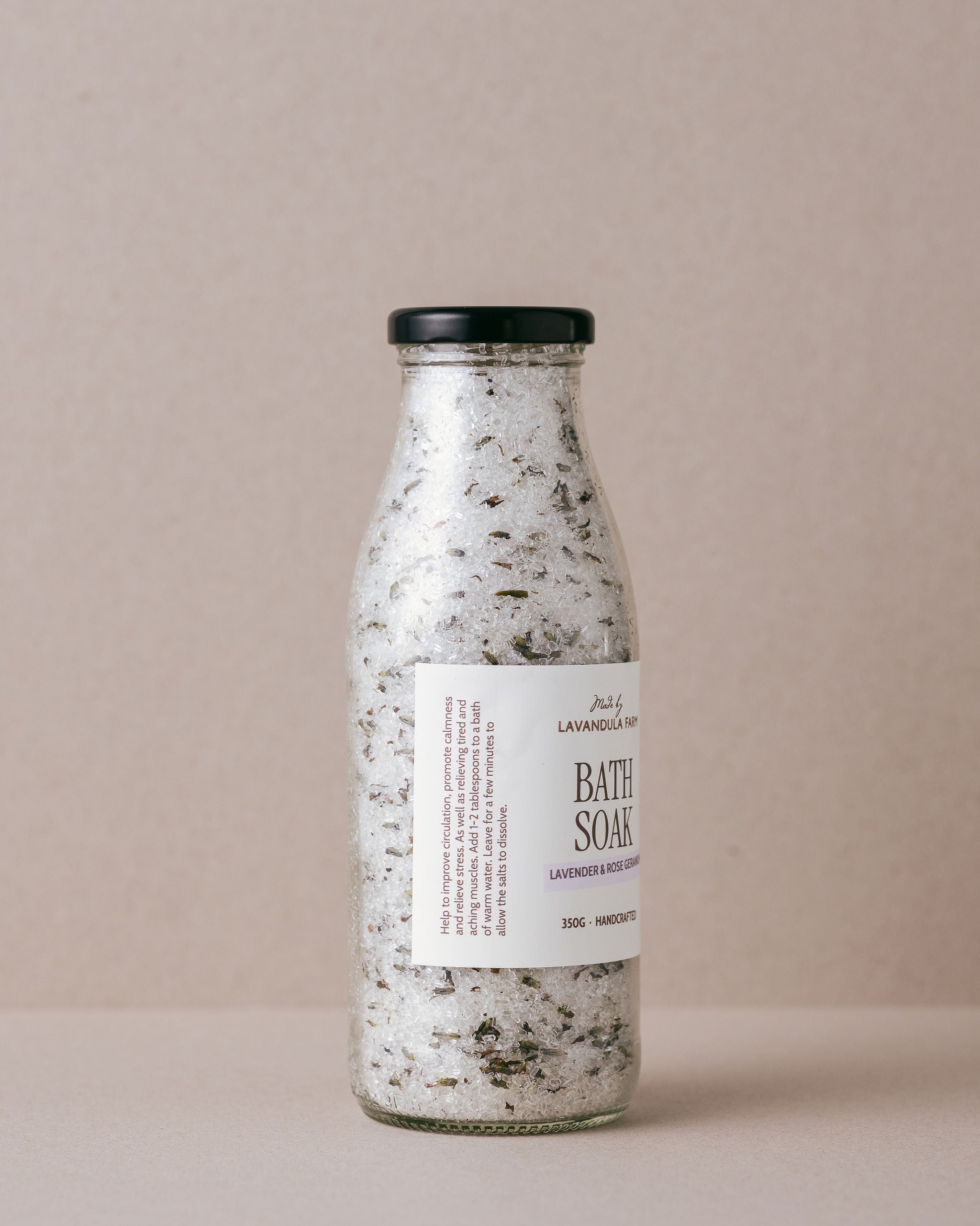 Lavender and Rose Geranium bath soak in a glass bottle
