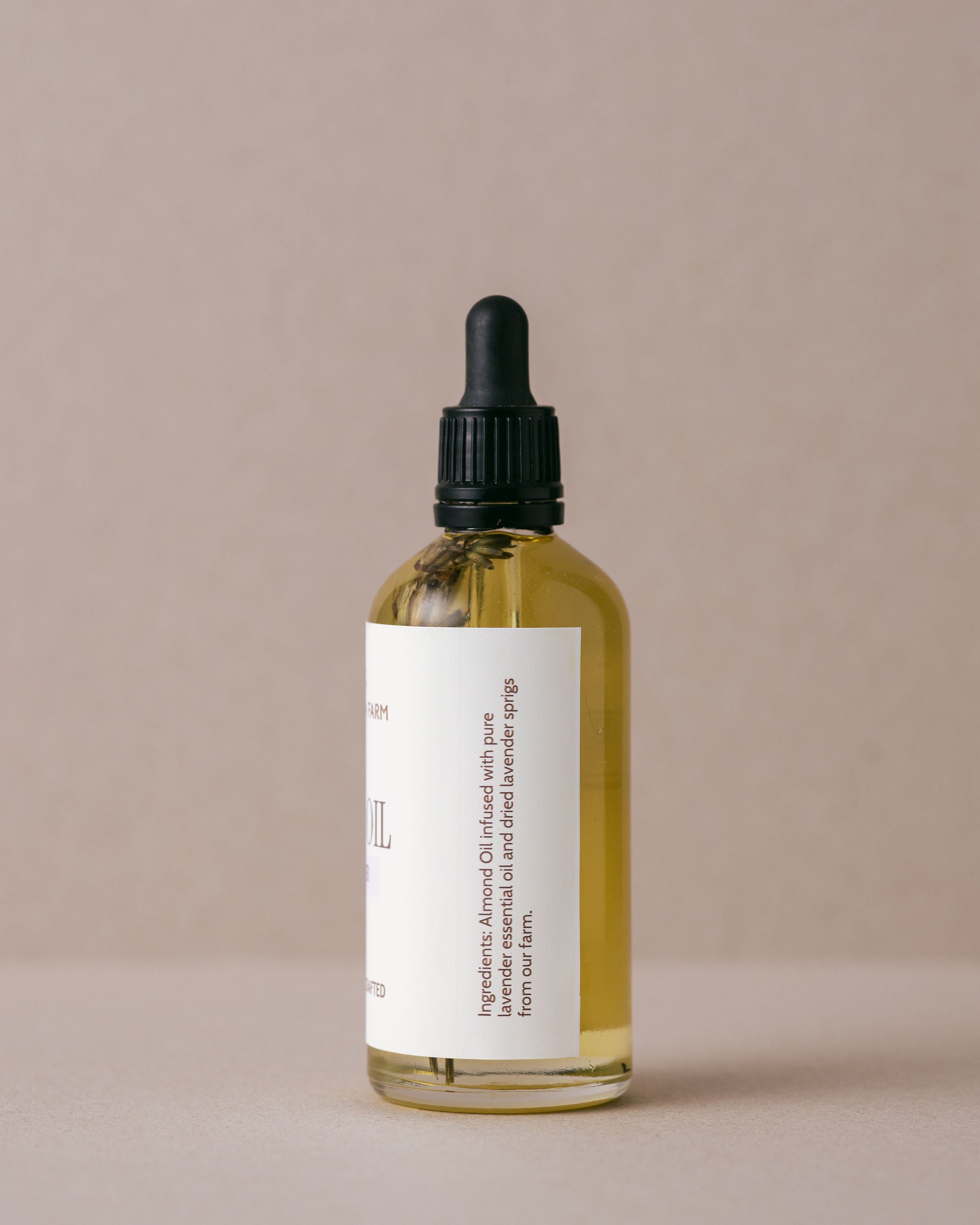 Luxurious lavender body oil in a glass bottle with a glass dropper handmade with natural ingredients at Lavandula Farm
