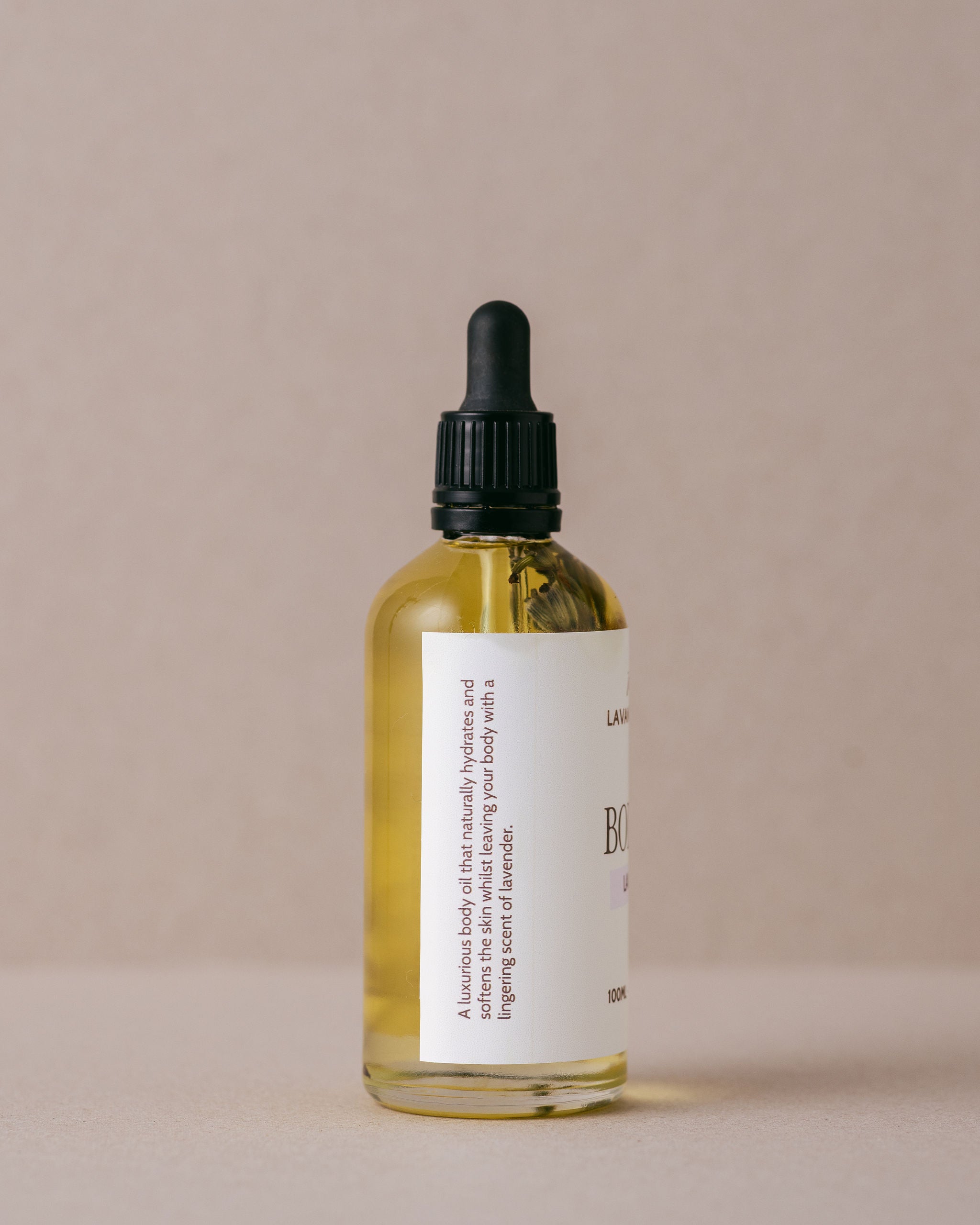 Luxurious lavender body oil in a glass bottle with a glass dropper handmade with natural ingredients at Lavandula Farm