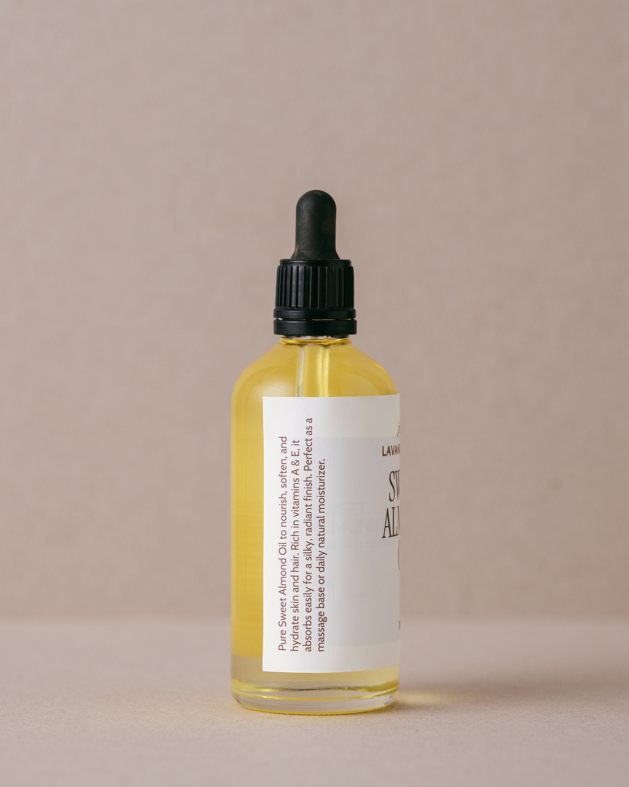 Pure natural sweet almond oil in a glass bottle with glass dropper