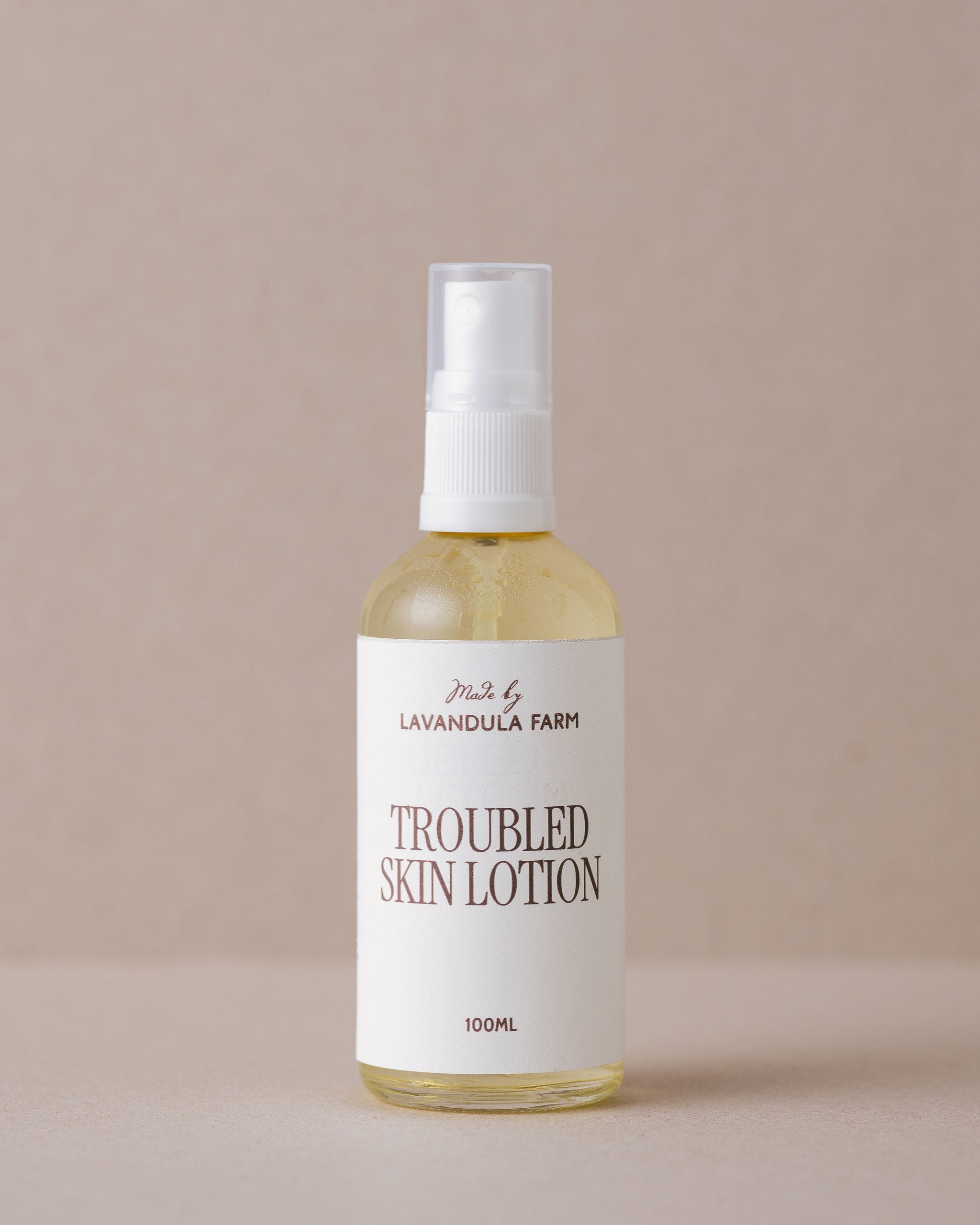A specialised face lotion for troubled skin in a glass bottle handmade at Lavandula Farm