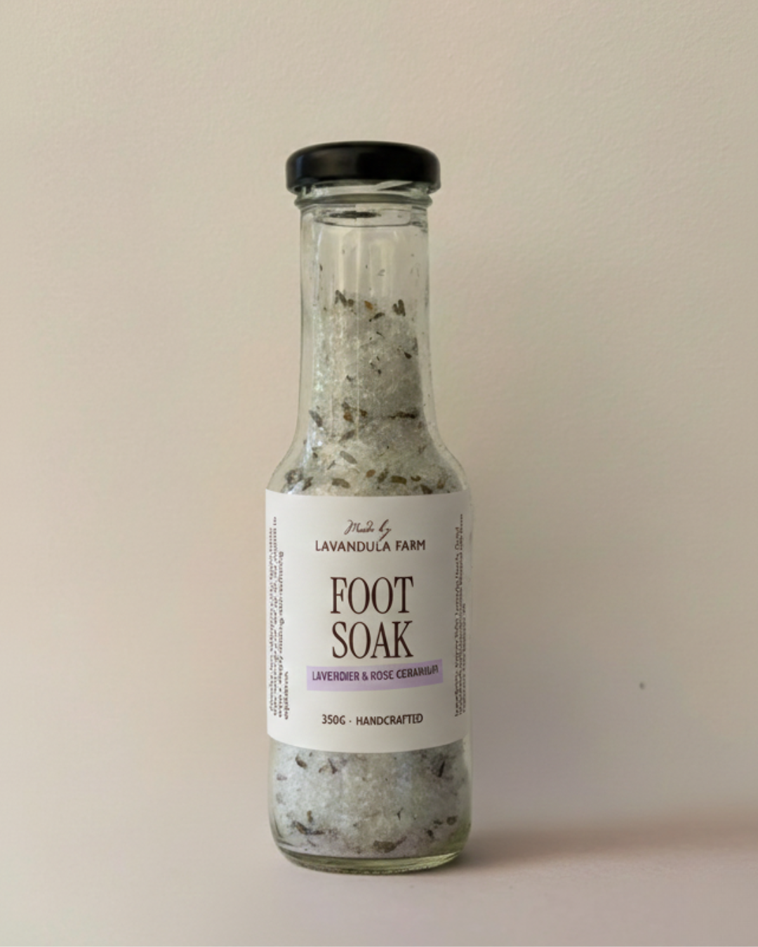 Image of glass bottle with black lid with foot soak habdmade at lavandula farm