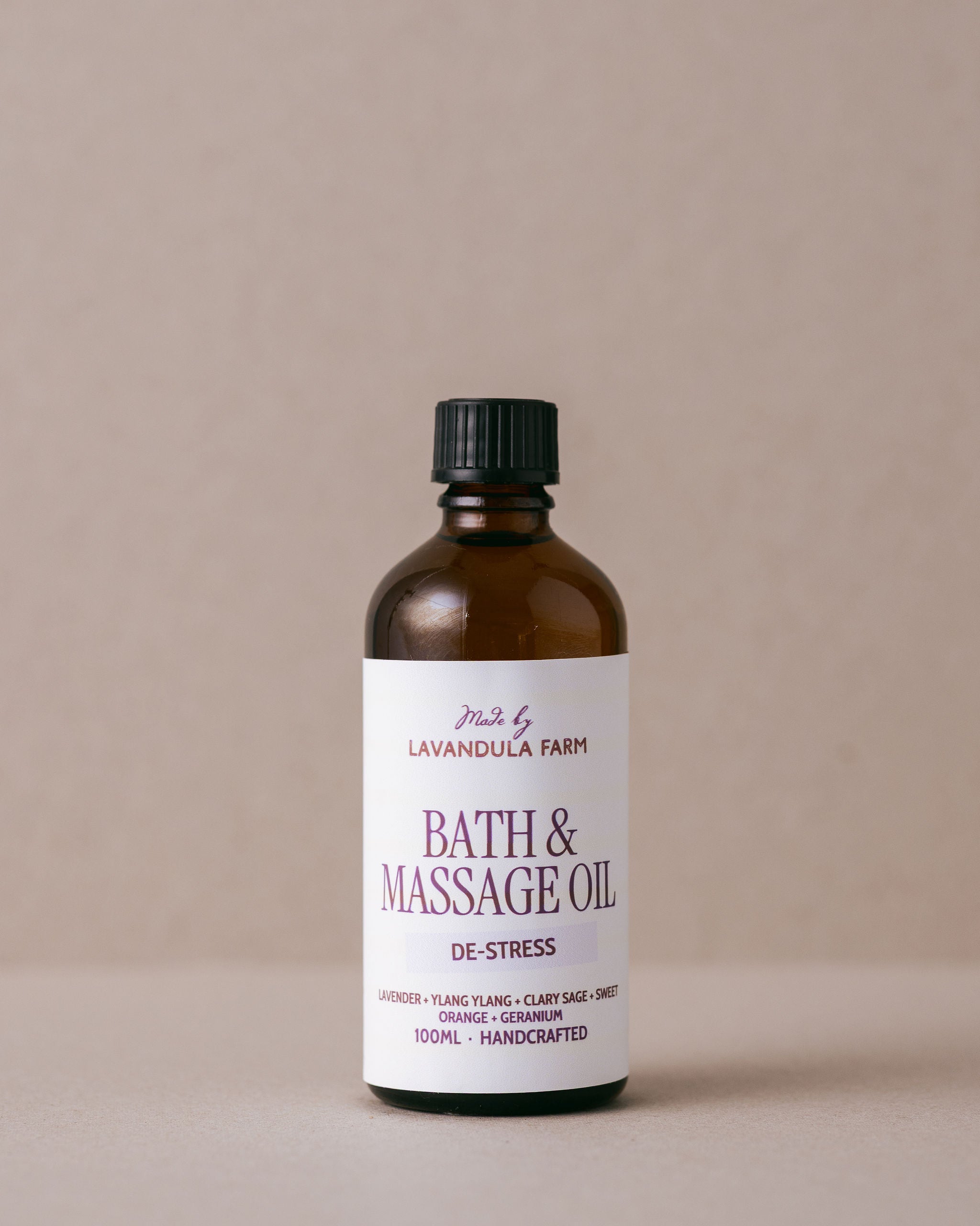 Bottle of bath and massage oil from Lavandula Farm on a beige background