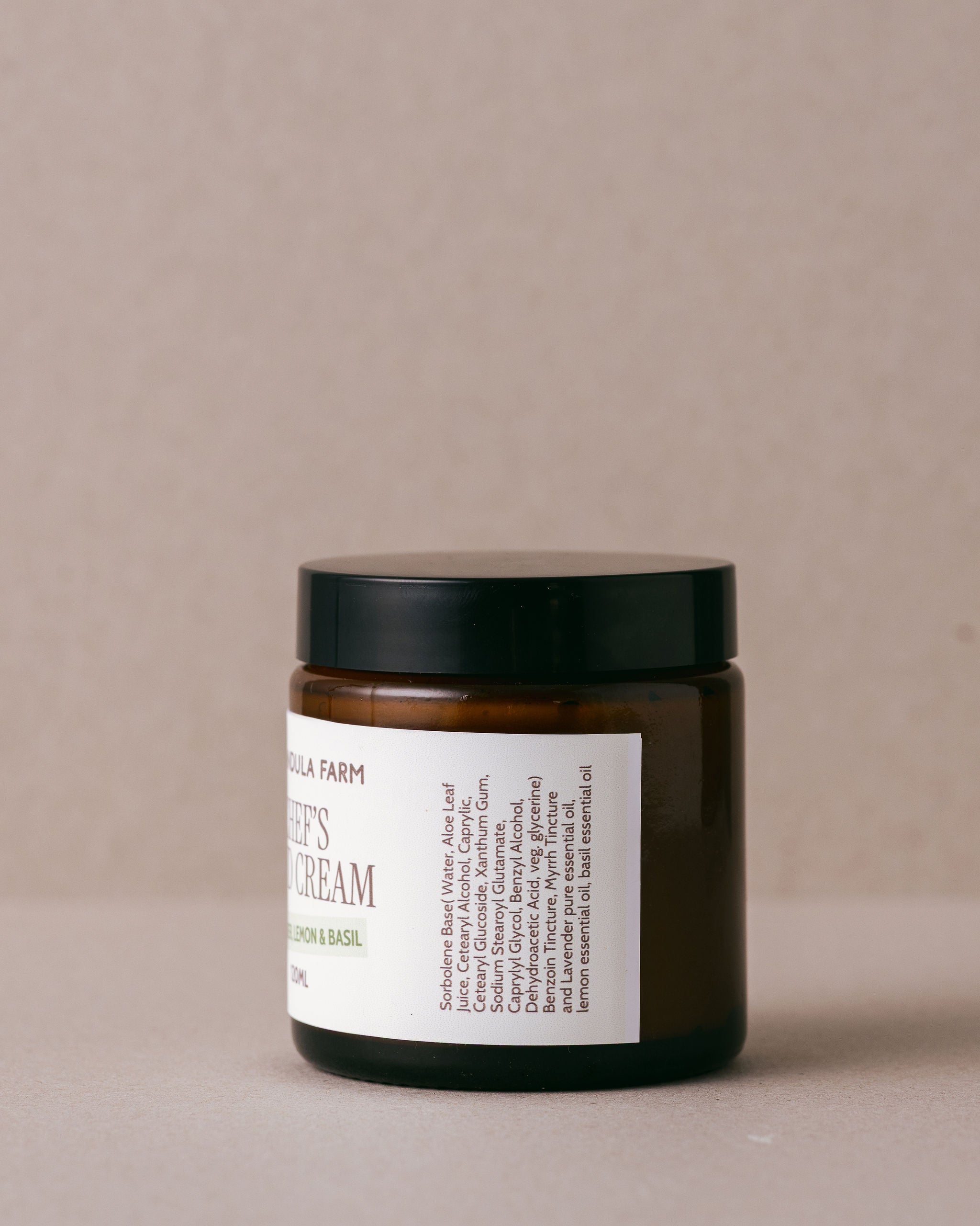Jar of cream with a label on a beige background