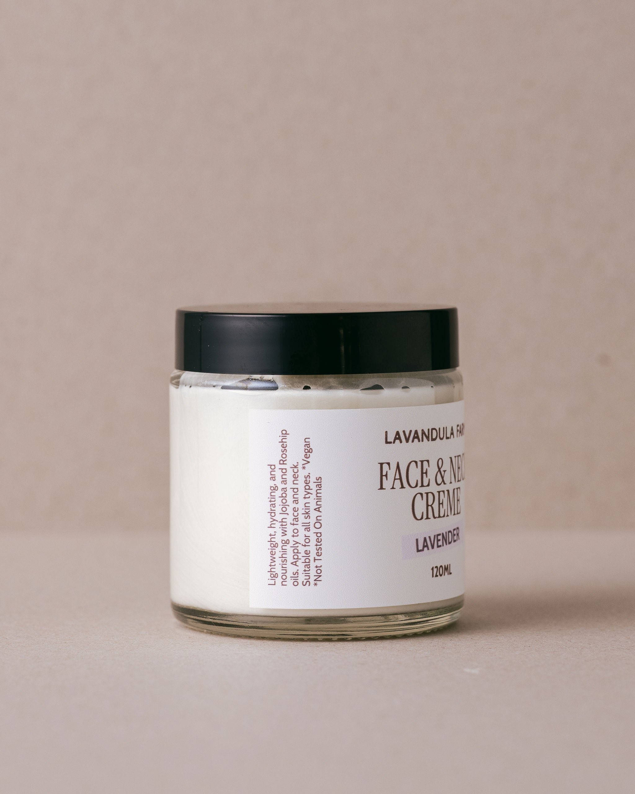 Face and neck creme in a glass jar with a white label handmade at Lavandula Farm