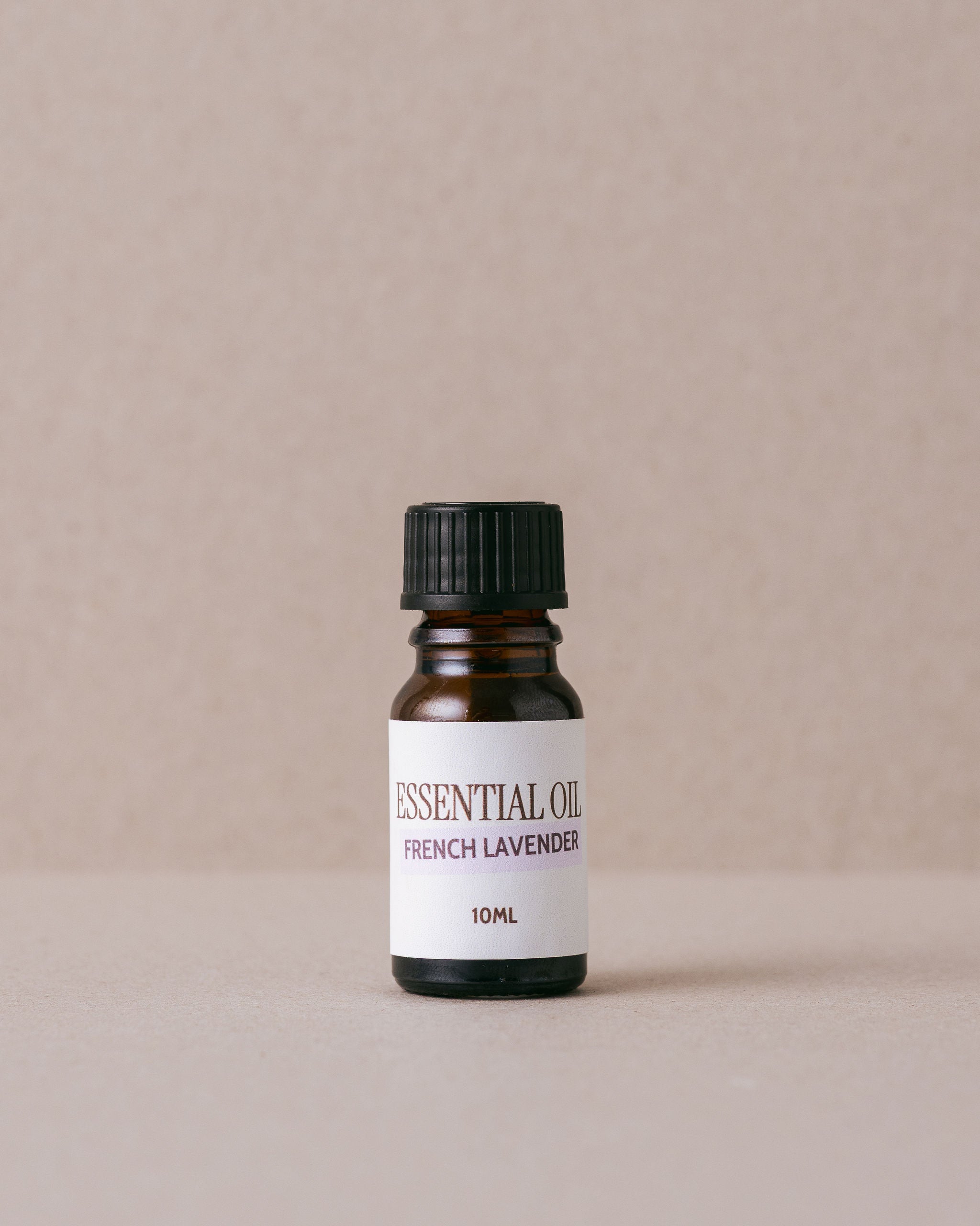 Bottle of French Lavender essential oil on a beige background