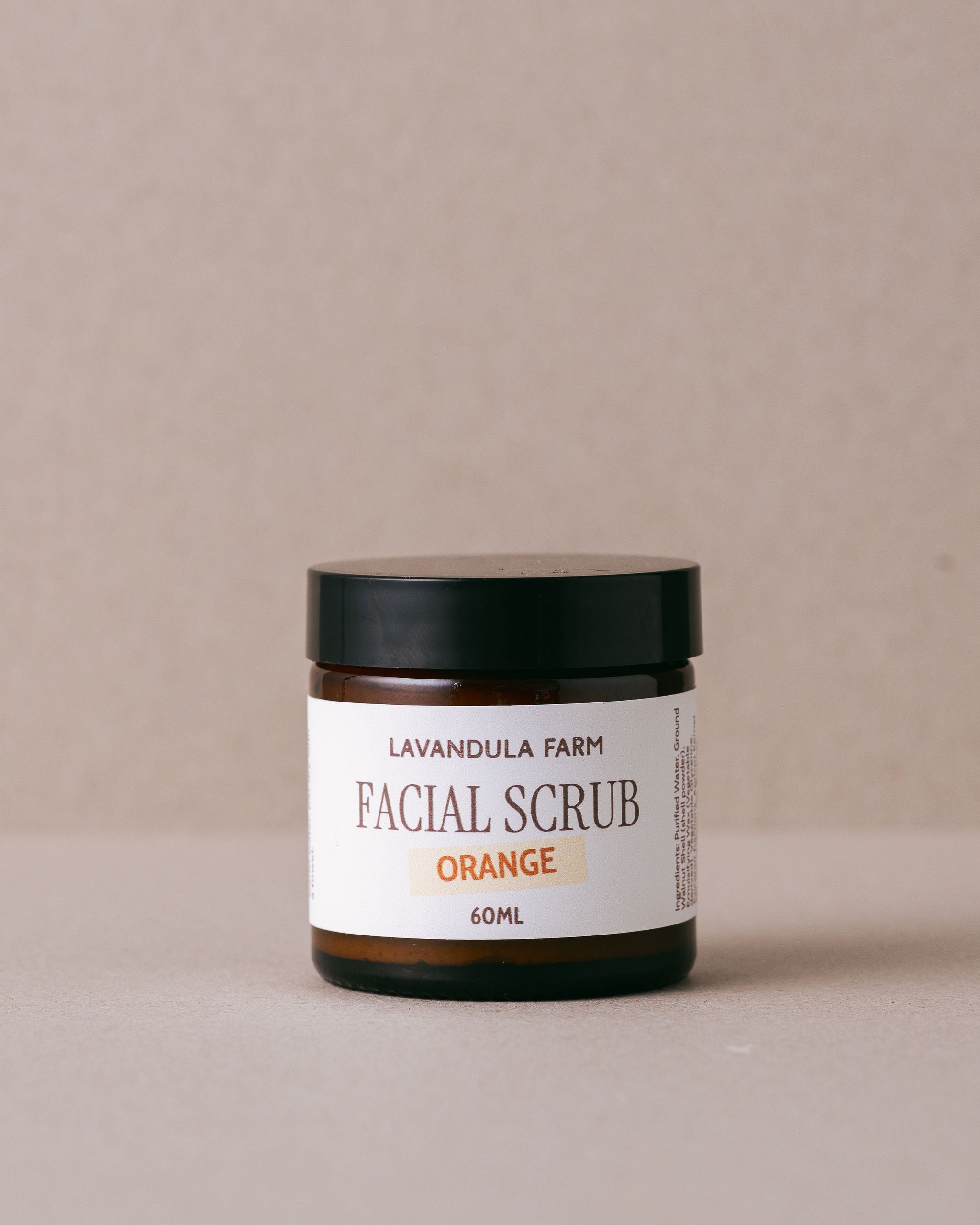 Orange facial scrub in a glass jar handmade with natural ingredients at Lavandula Farm