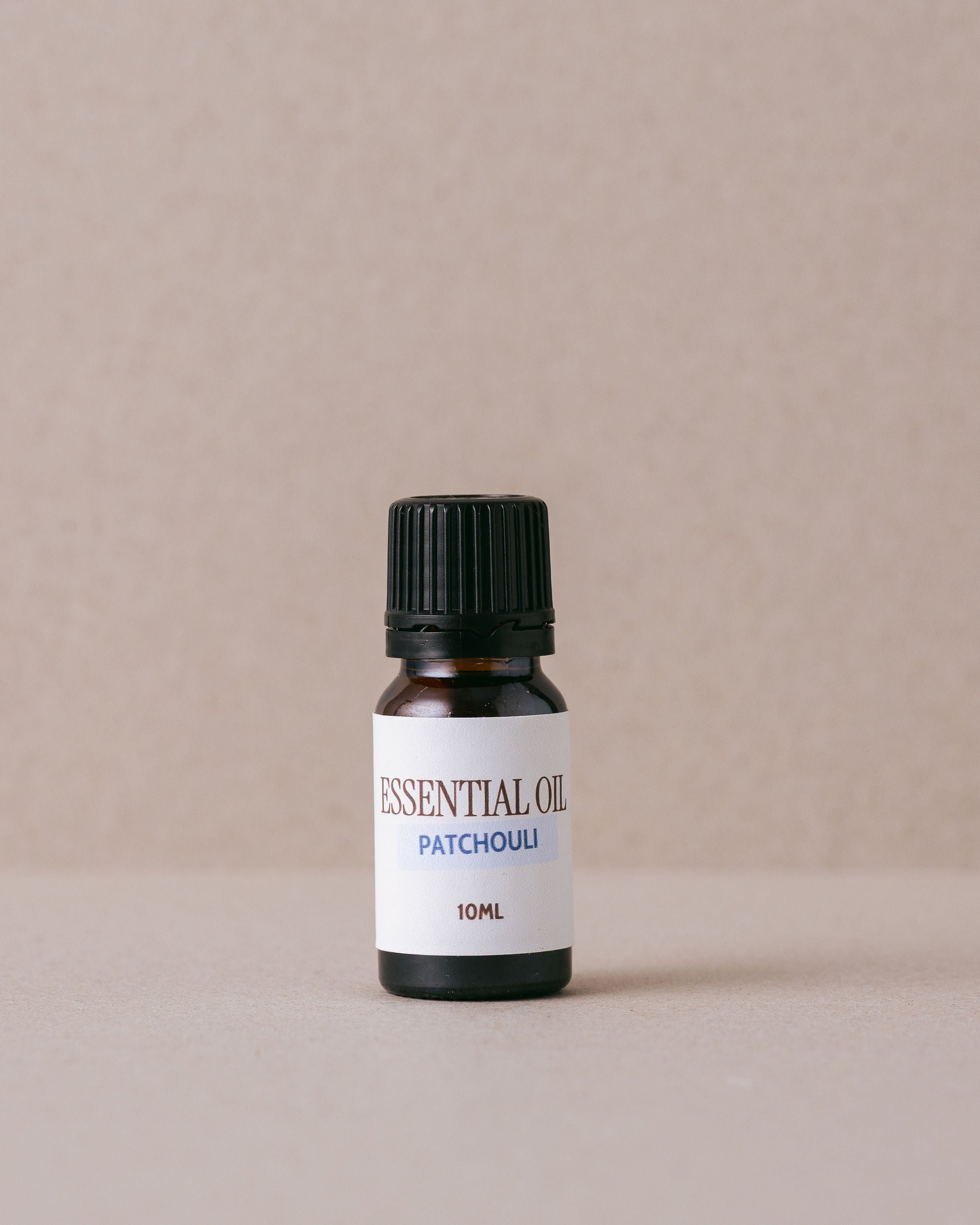 patchouli pure essential oil on a beige background