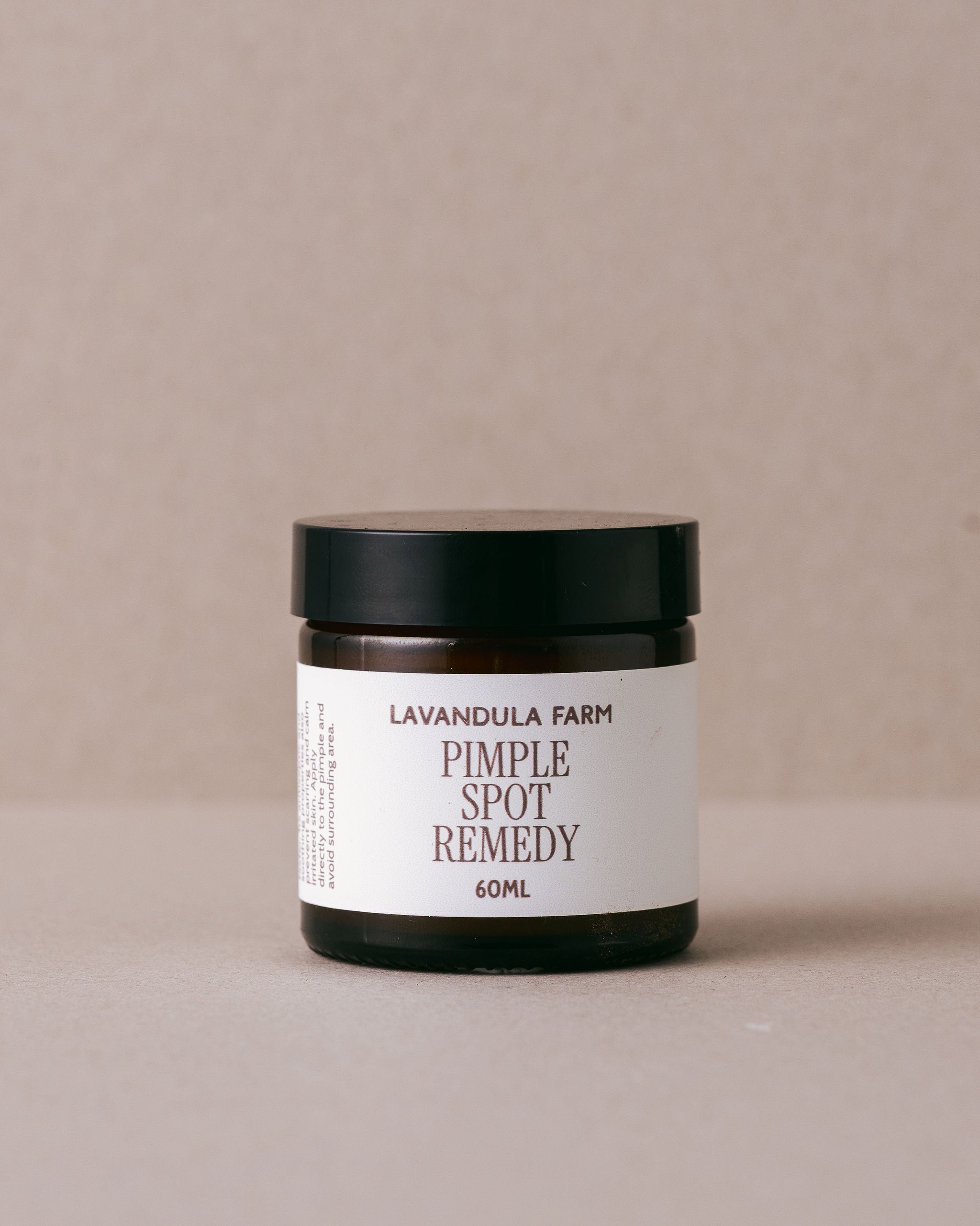 Jar of 'Pimple Spot Remedy' from Lavandula Farm on a beige background