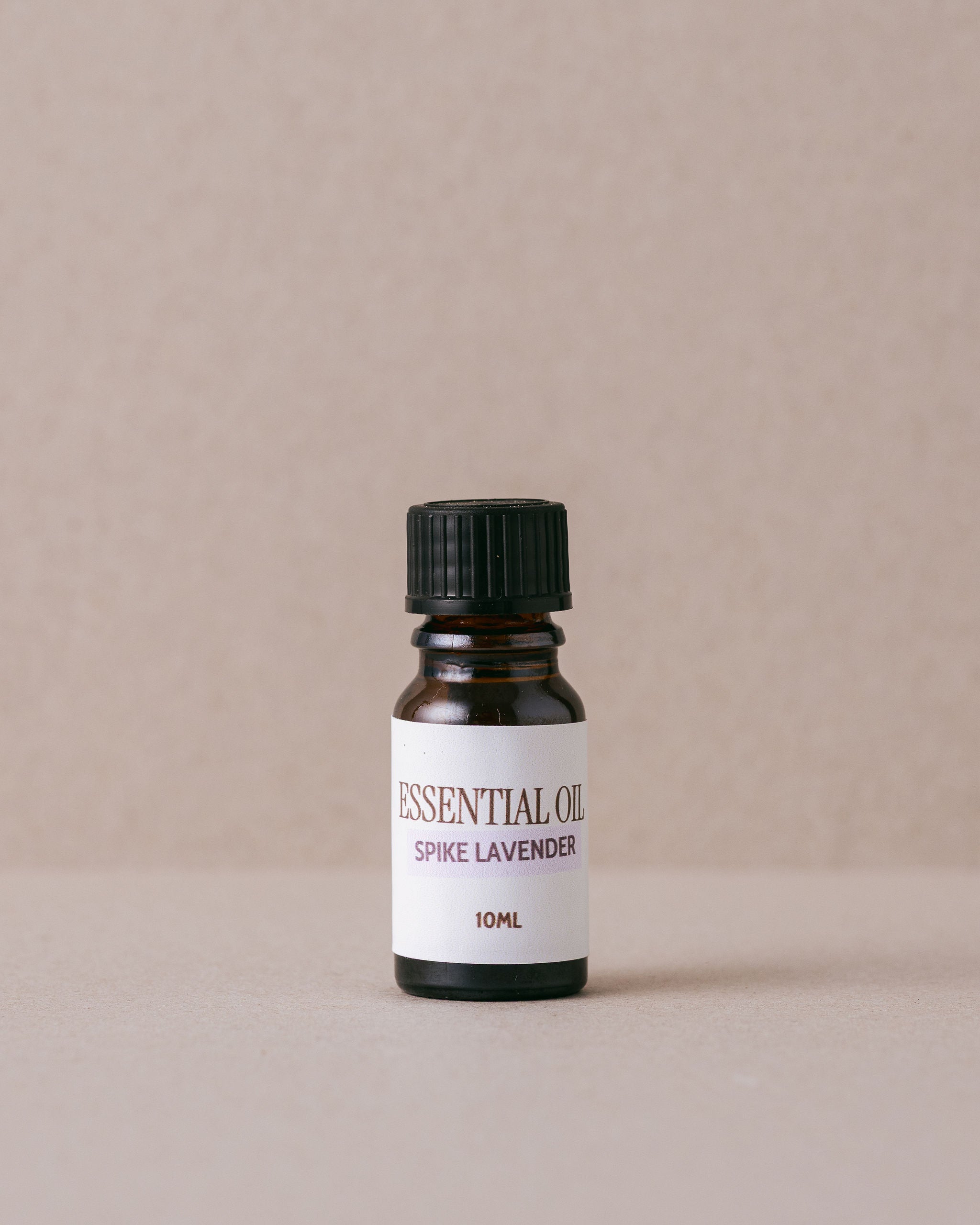 spike lavender essential oil on a beige background